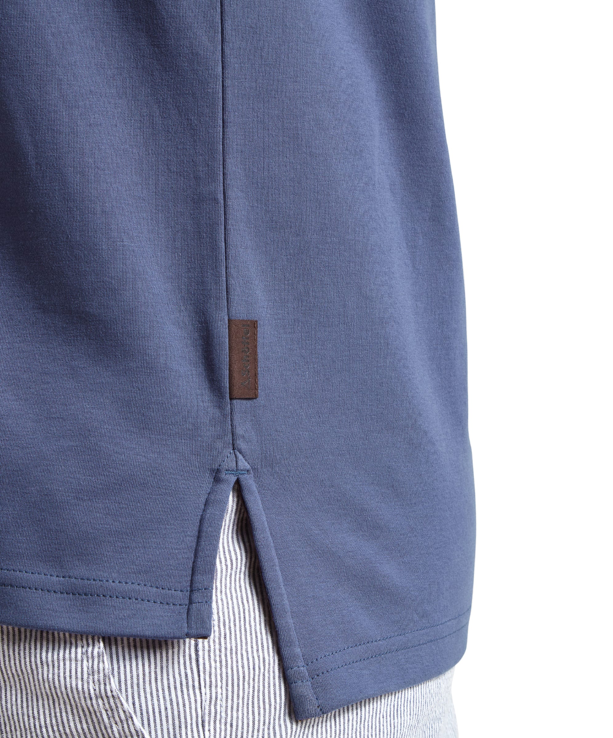 Detailed image of the Schöffel St Ives Jersey Polo Shirt for Men in Blue, highlighting the side seam split and the logo tag near the hem.