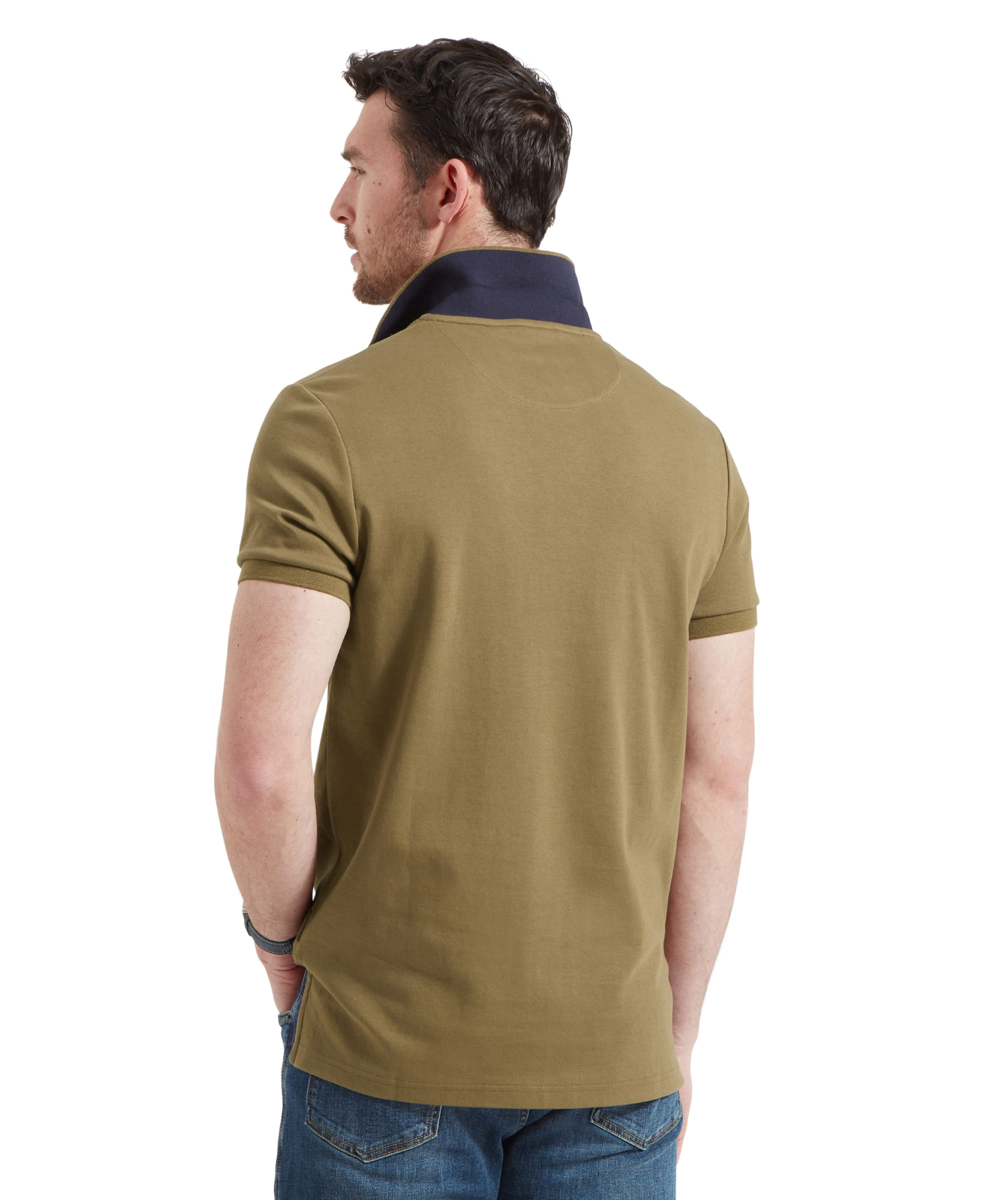 Rear view of the man, highlighting the back of the polo shirt and the dark contrast collar.