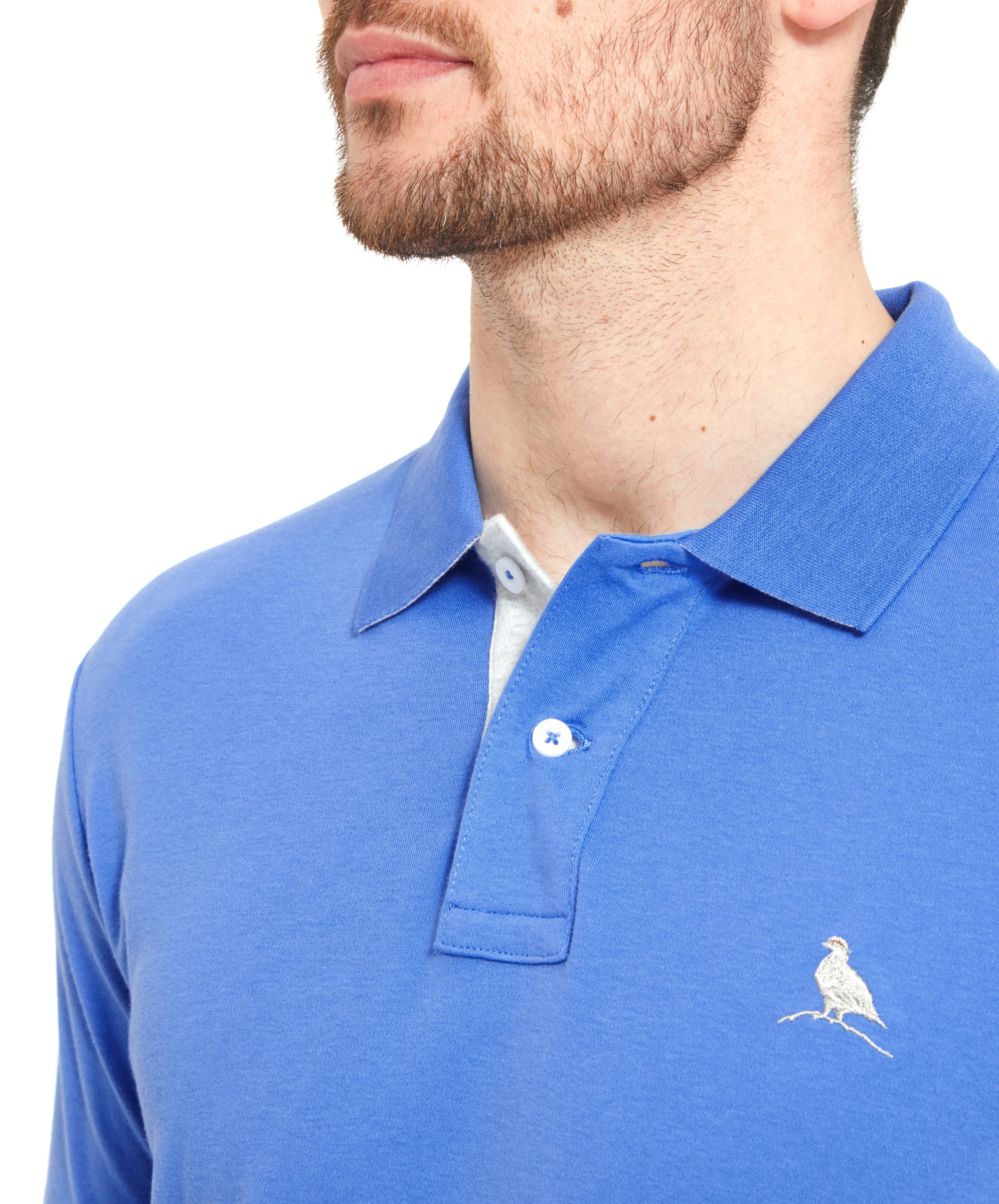 Close-up of the collar area, showcasing the contrasting inner lining and the button details. The embroidered Ptarmigan logo is clearly visible on the left chest.