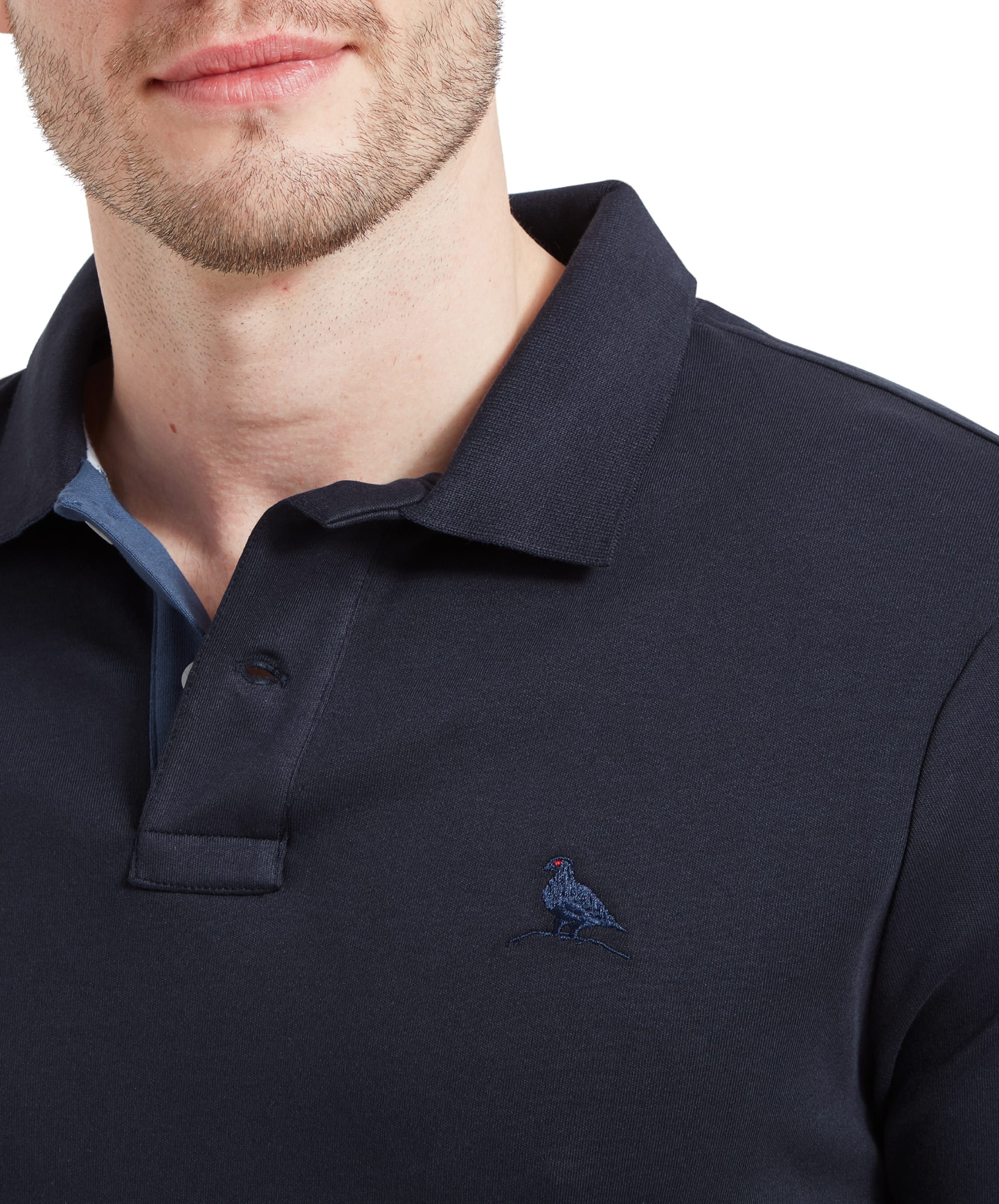 Close-up of the collar area, showcasing the button details and the embroidered bird logo on the left chest. The inner lining of the collar is also visible, providing a subtle contrast.