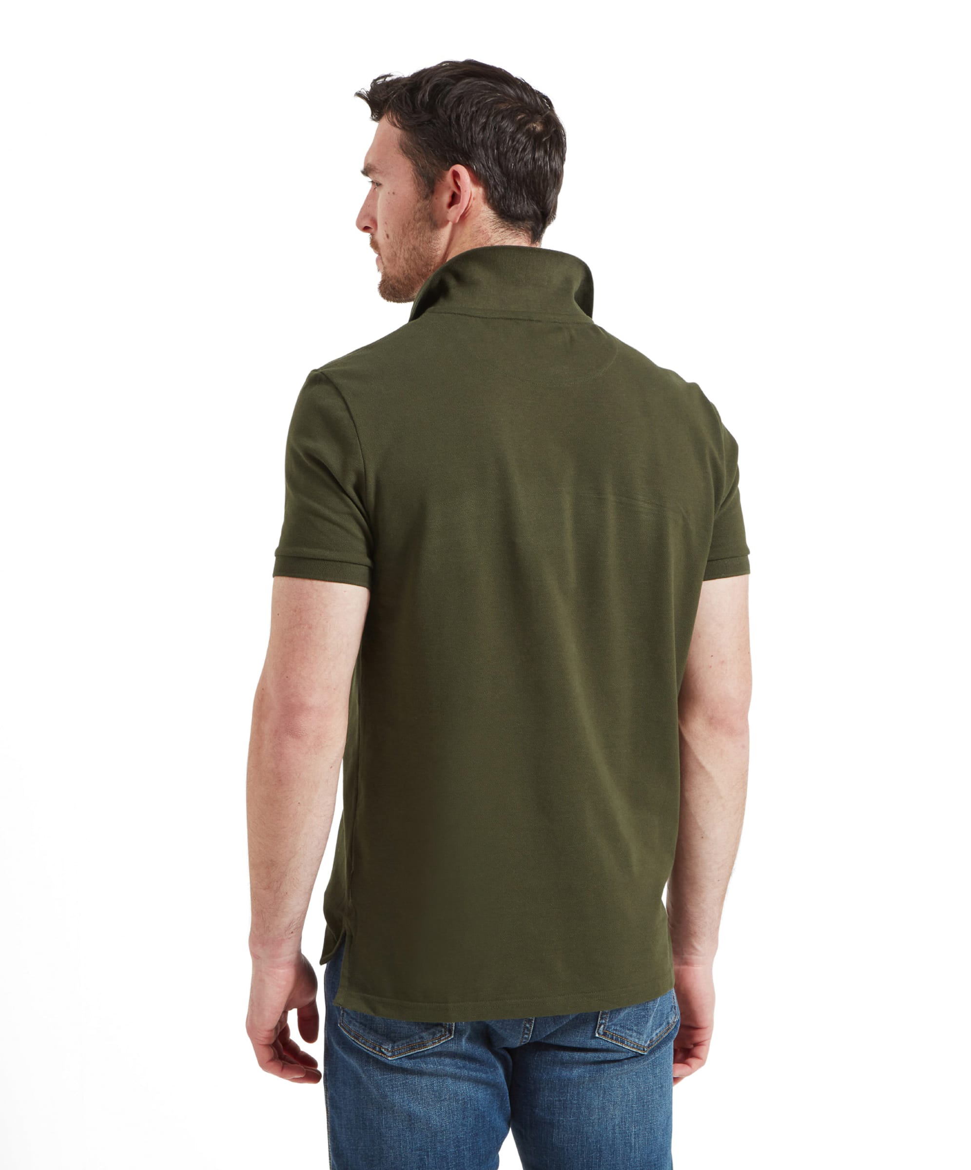 Rear view of the man, showing the back of the polo shirt and the collar detail, emphasizing the shirt's fit.