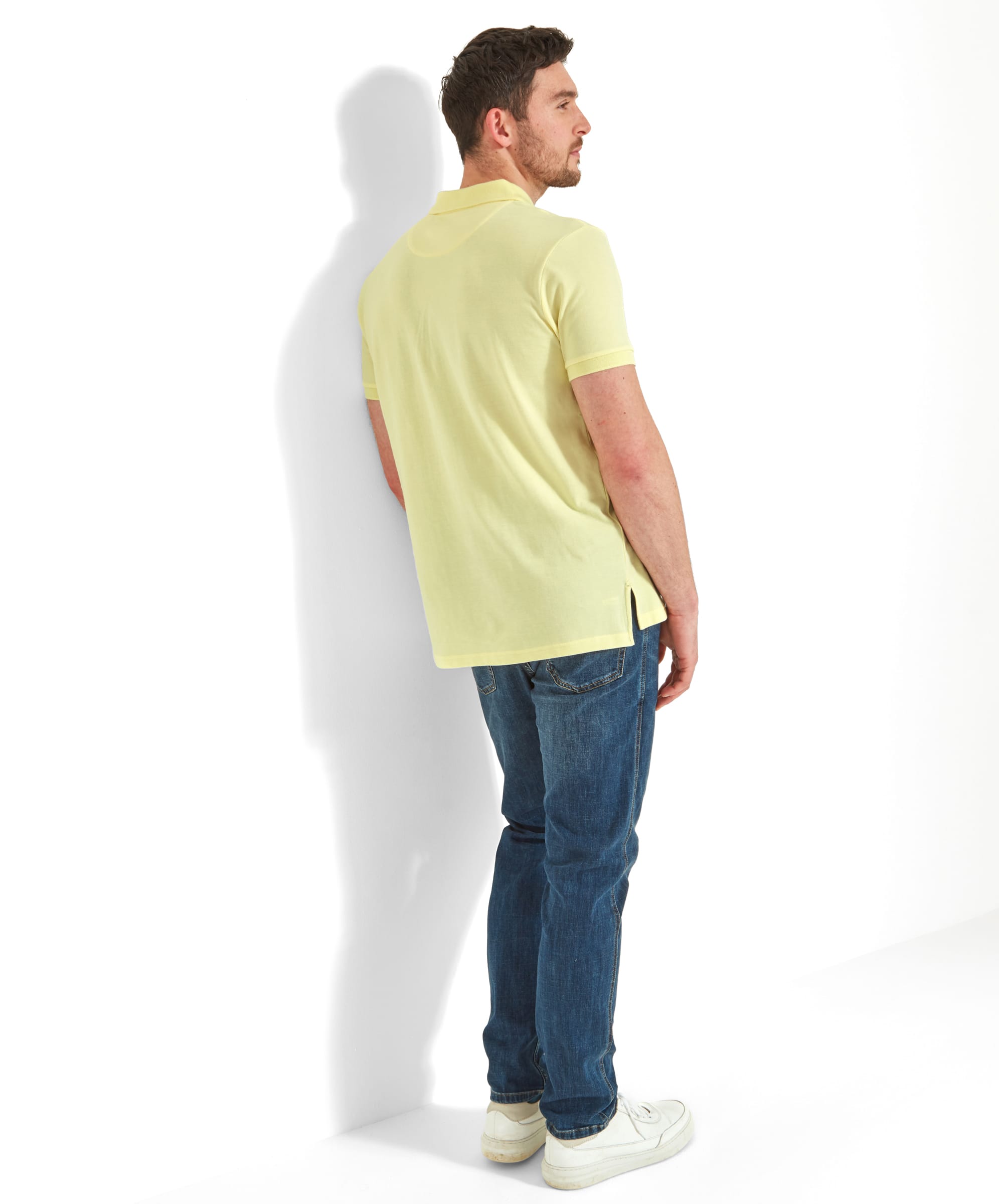 Rear view of the man, highlighting the back of the Schöffel St Ives Polo Shirt for Men in Light Yellow and its fit.