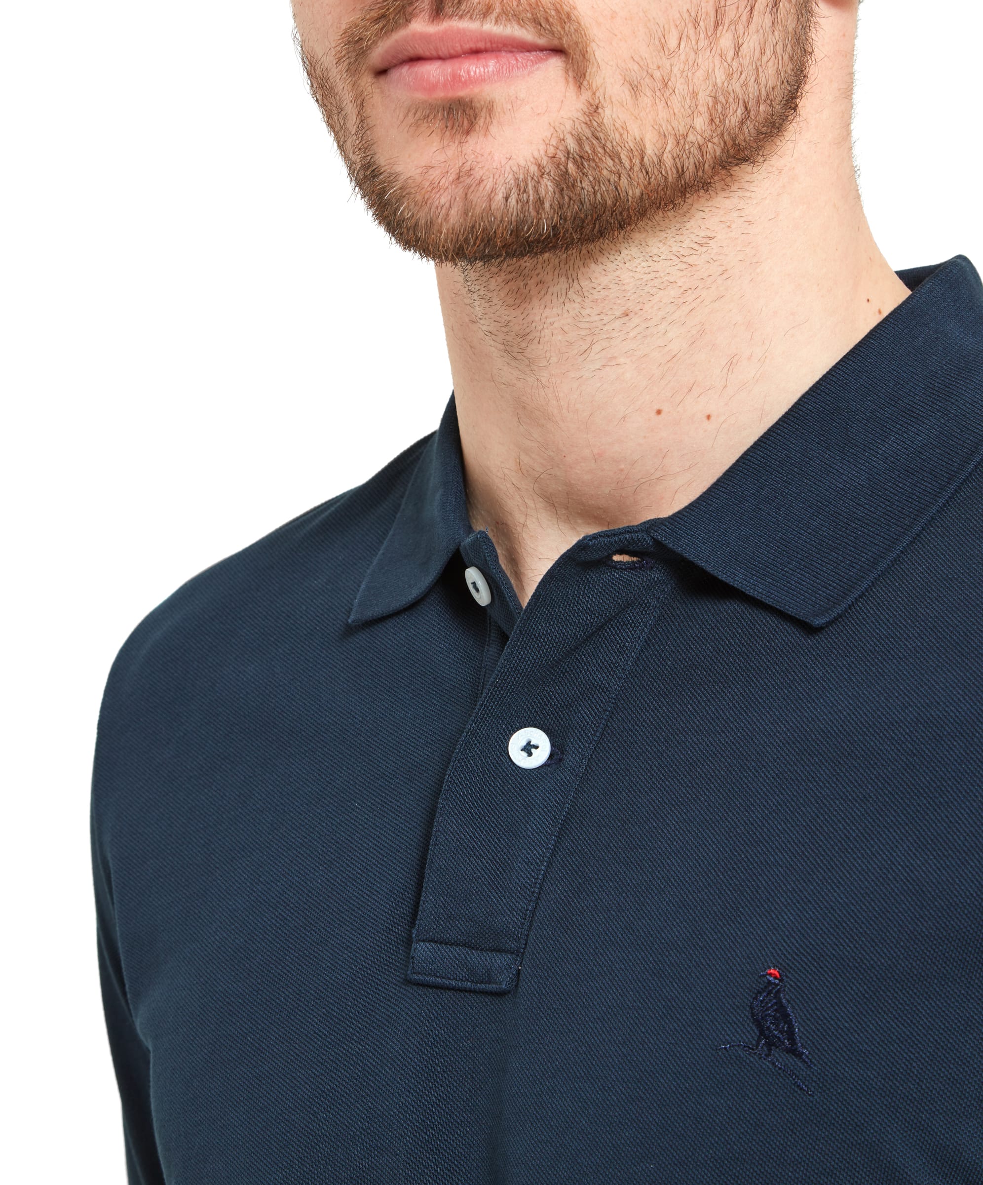 Close-up of the collar area of the Schöffel St Ives Polo Shirt for Men in Navy, showcasing the button details and the embroidered Ptarmigan logo on the left chest. The navy colour provides a versatile and classic style.