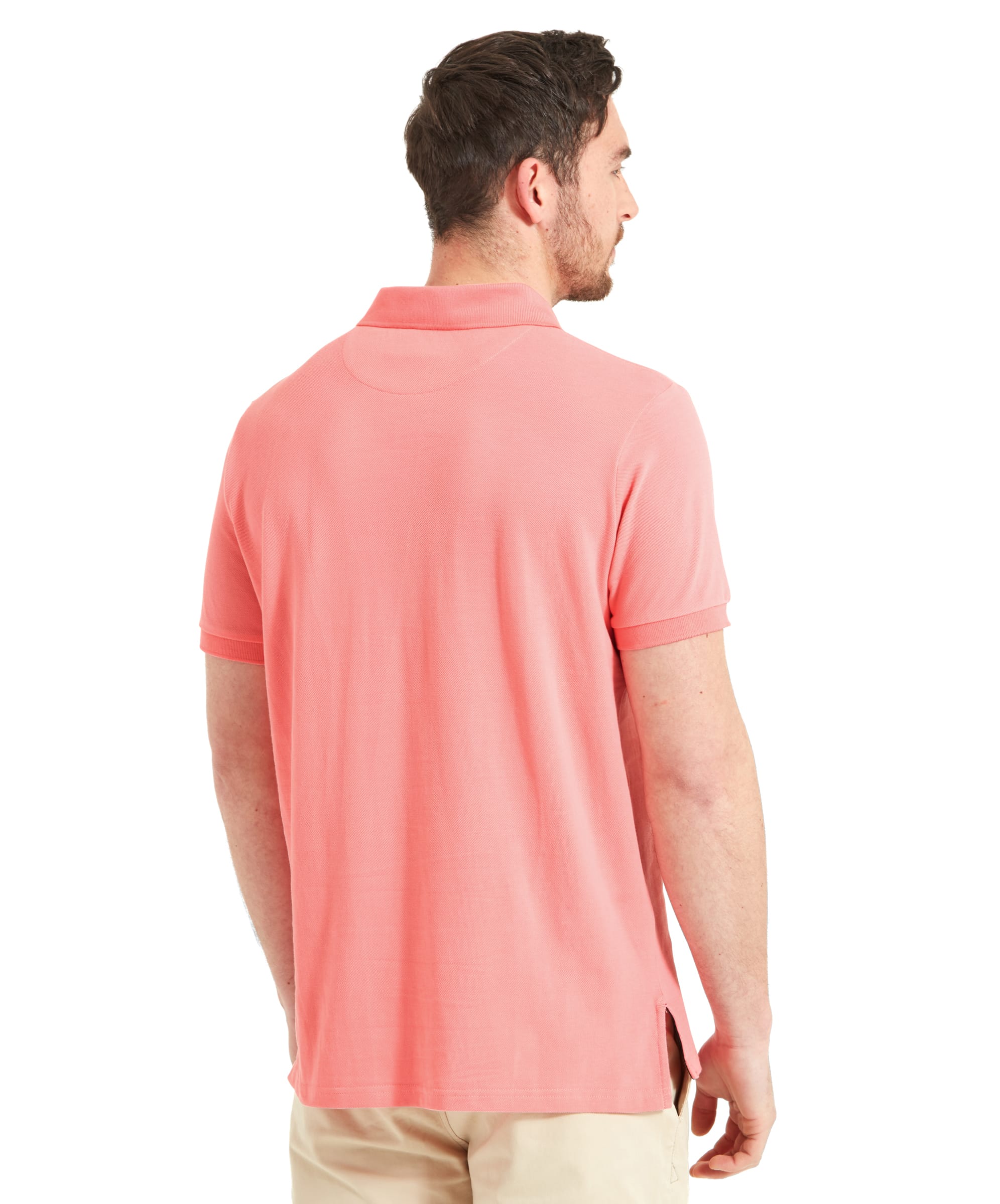 Rear view of the man, showcasing the back of the Schöffel St Ives Polo Shirt for Men in Pink and its fit. The soft pink color is complemented by the simple design, emphasizing comfort and style.