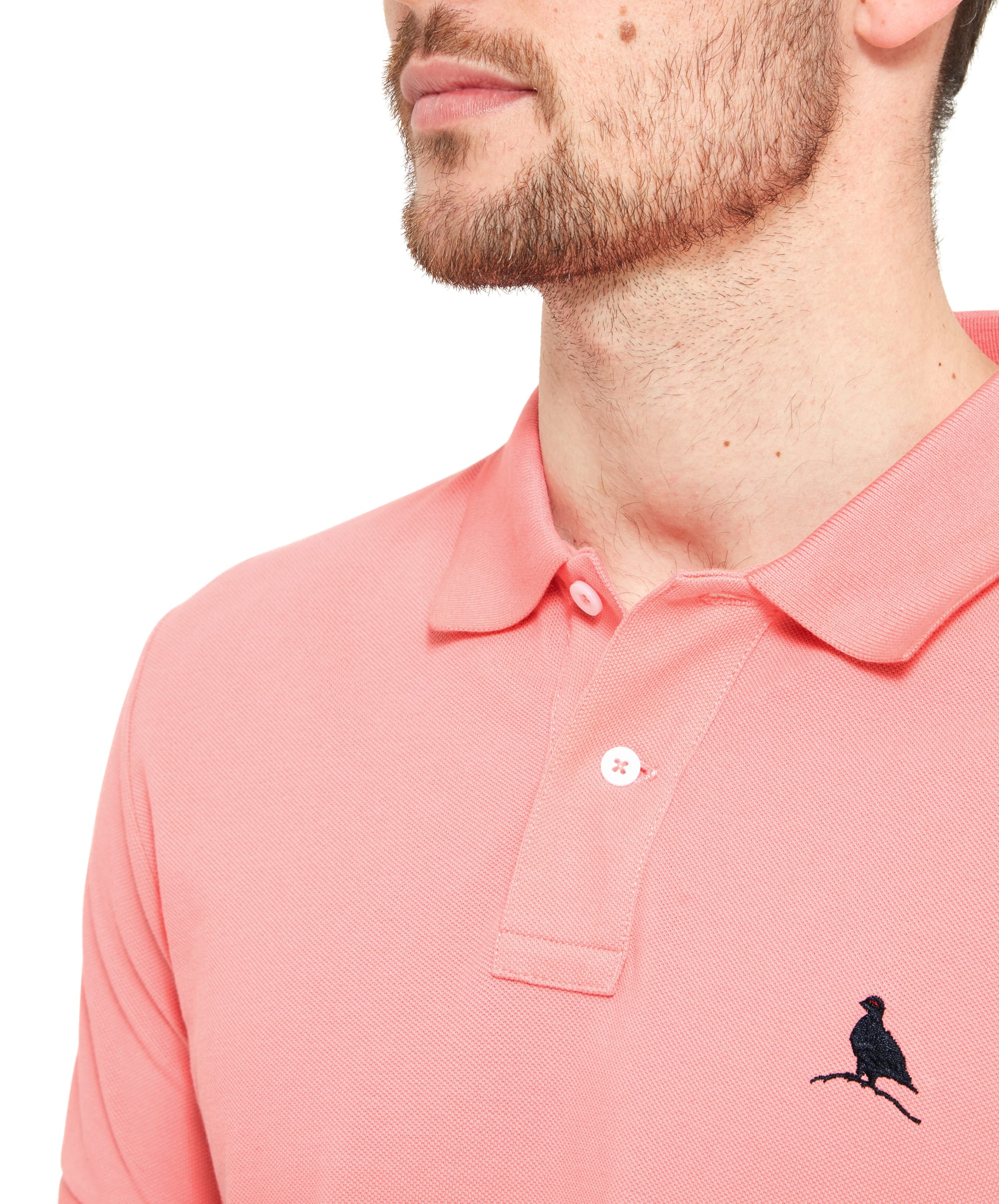 Close-up of the collar and embroidered bird logo, emphasizing the Schöffel St Ives Polo Shirt for Men in Pink's detailing and quality craftsmanship.