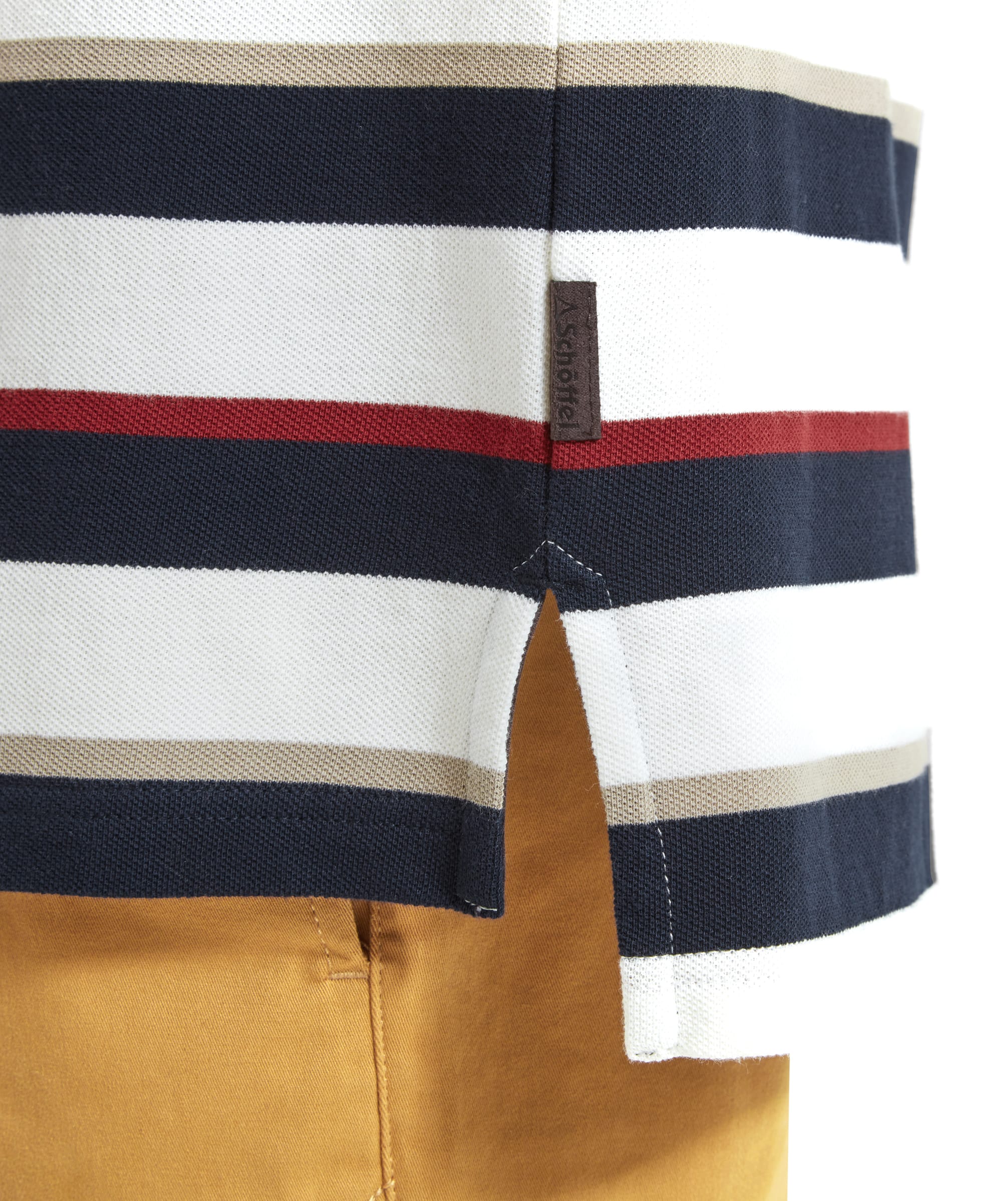 A detailed view of the Schöffel St Ives Polo Shirt for Men in Red's hem, showing the side slit and a small tag. The stripe pattern continues seamlessly, underlining the quality craftsmanship.