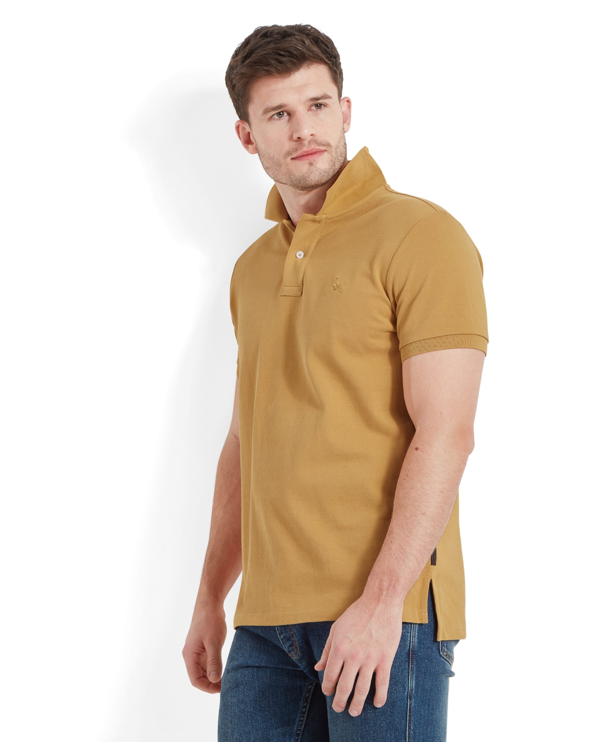 A side profile of the man wearing the Schöffel St Ives Polo Shirt for Men in Yellow, showing the fit and detailing of the shirt, including the split hem.