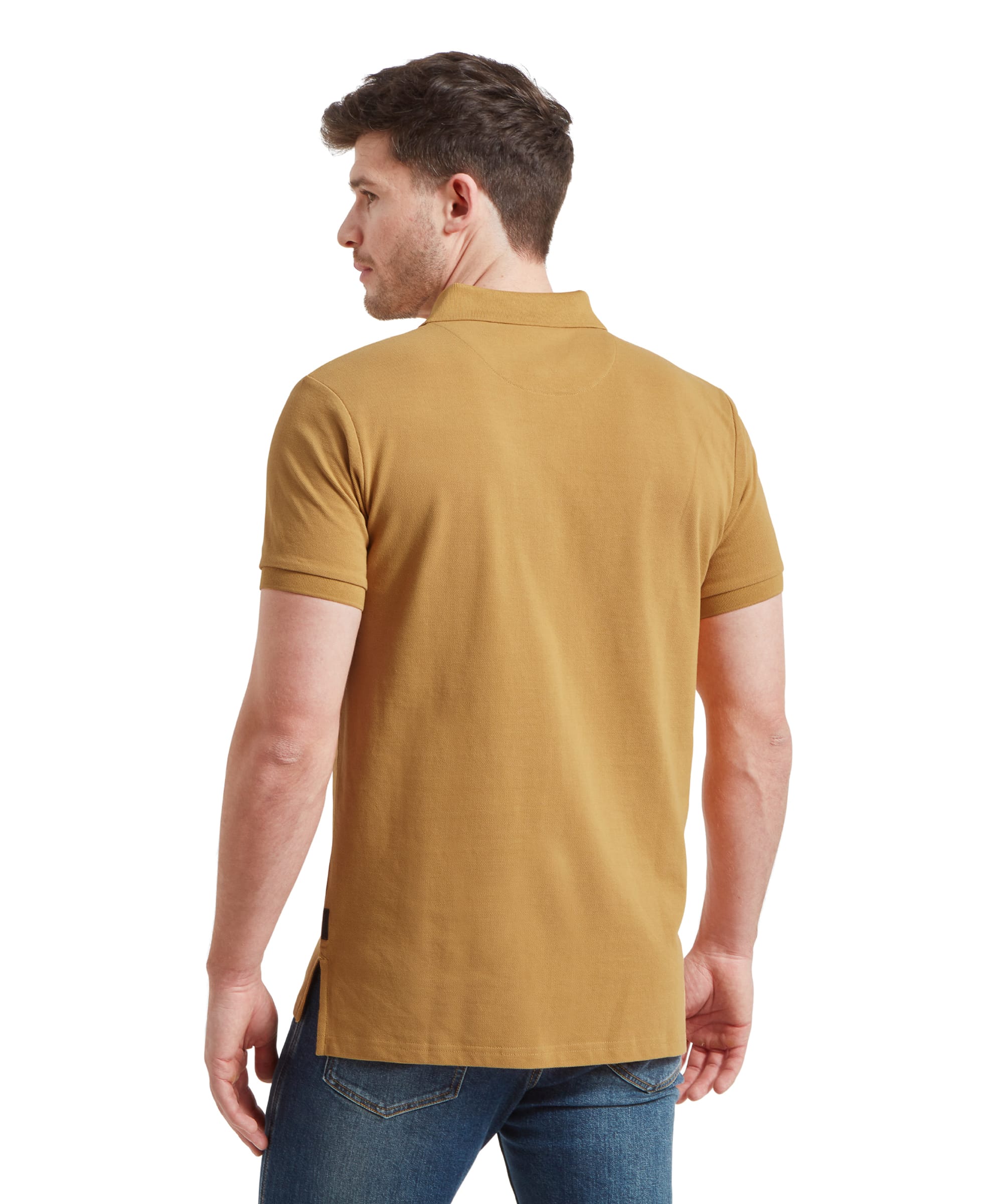 The back view of the Schöffel St Ives Polo Shirt for Men in Yellow, highlighting the fit and length, with the man’s hands behind his back.