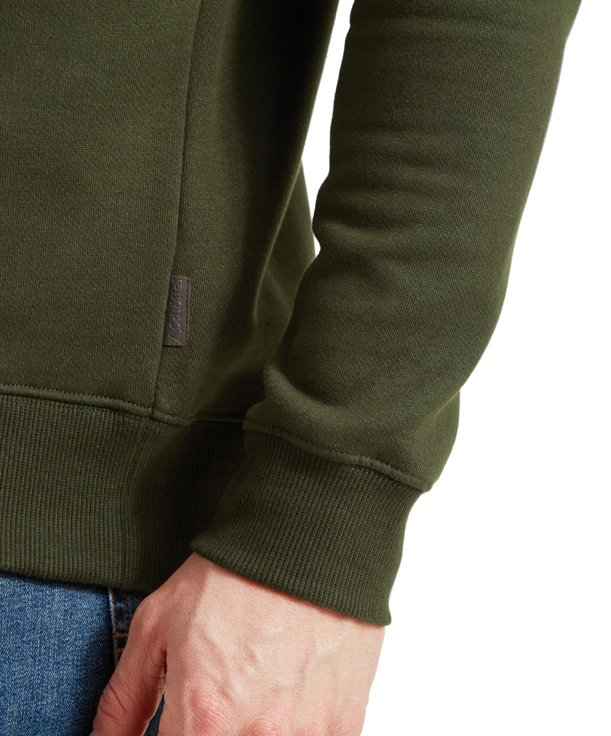 Close-up of the left sleeve and side seam of the Schöffel St Merryn Sweatshirt for Men in Dark Green, emphasizing the fabric texture and the small branded label at the hem.