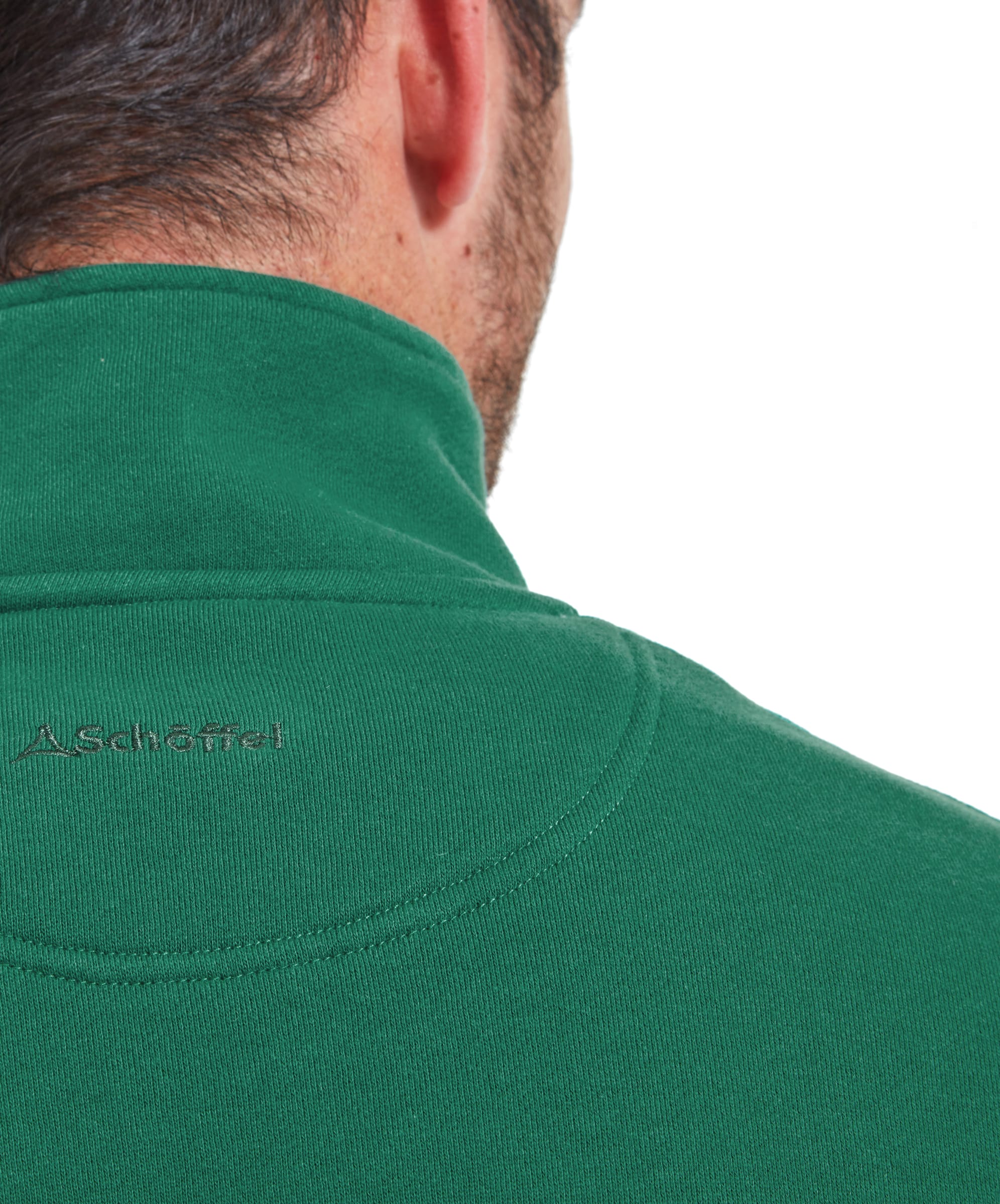 The back view of the man in the Schöffel St Merryn Sweatshirt for Men in Green, highlighting the stitching and the logo placement at the back of the collar. The sweatshirt is paired with blue jeans.