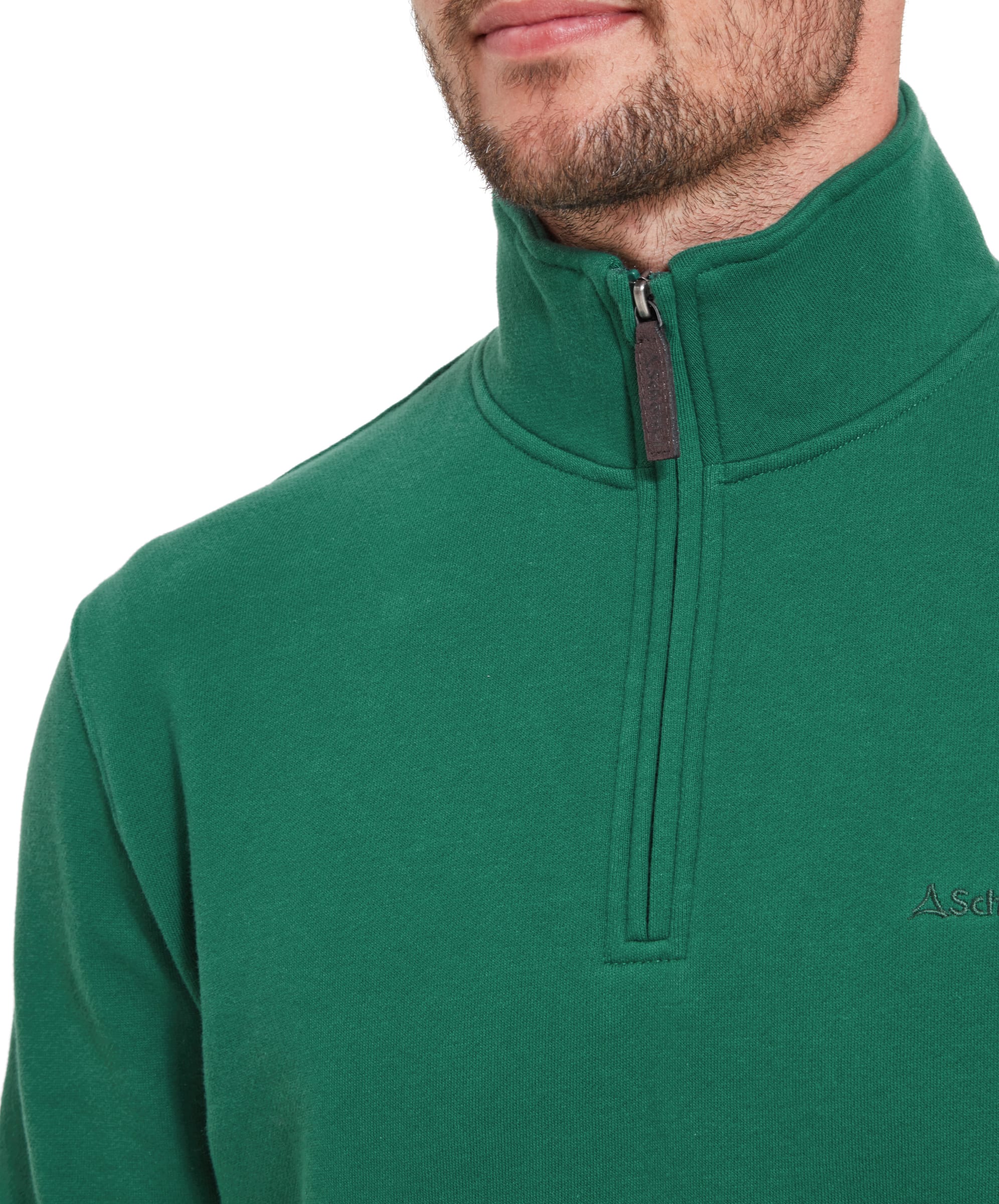 A close-up shot of the man wearing the Schöffel St Merryn Sweatshirt for Men in Green, focusing on the zipper detail and the small embroidered logo on the left chest.