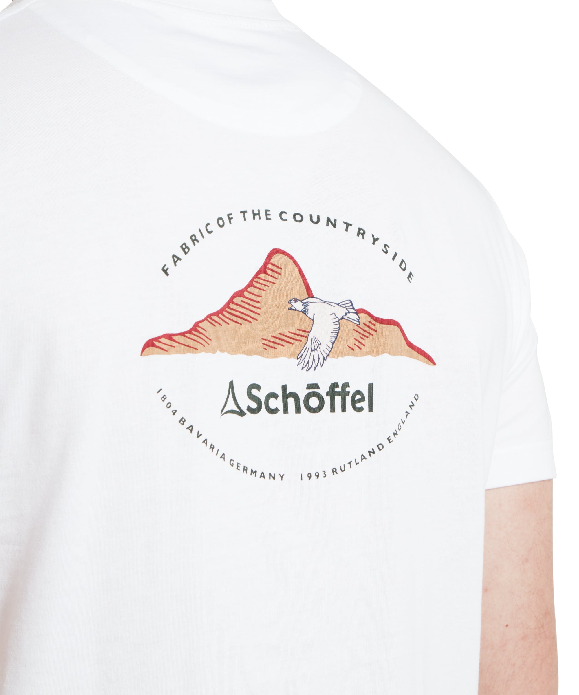 Back of a white shirt featuring a logo with mountains, a bird, and the text "Fabric of the Countryside" and "Schöffel".