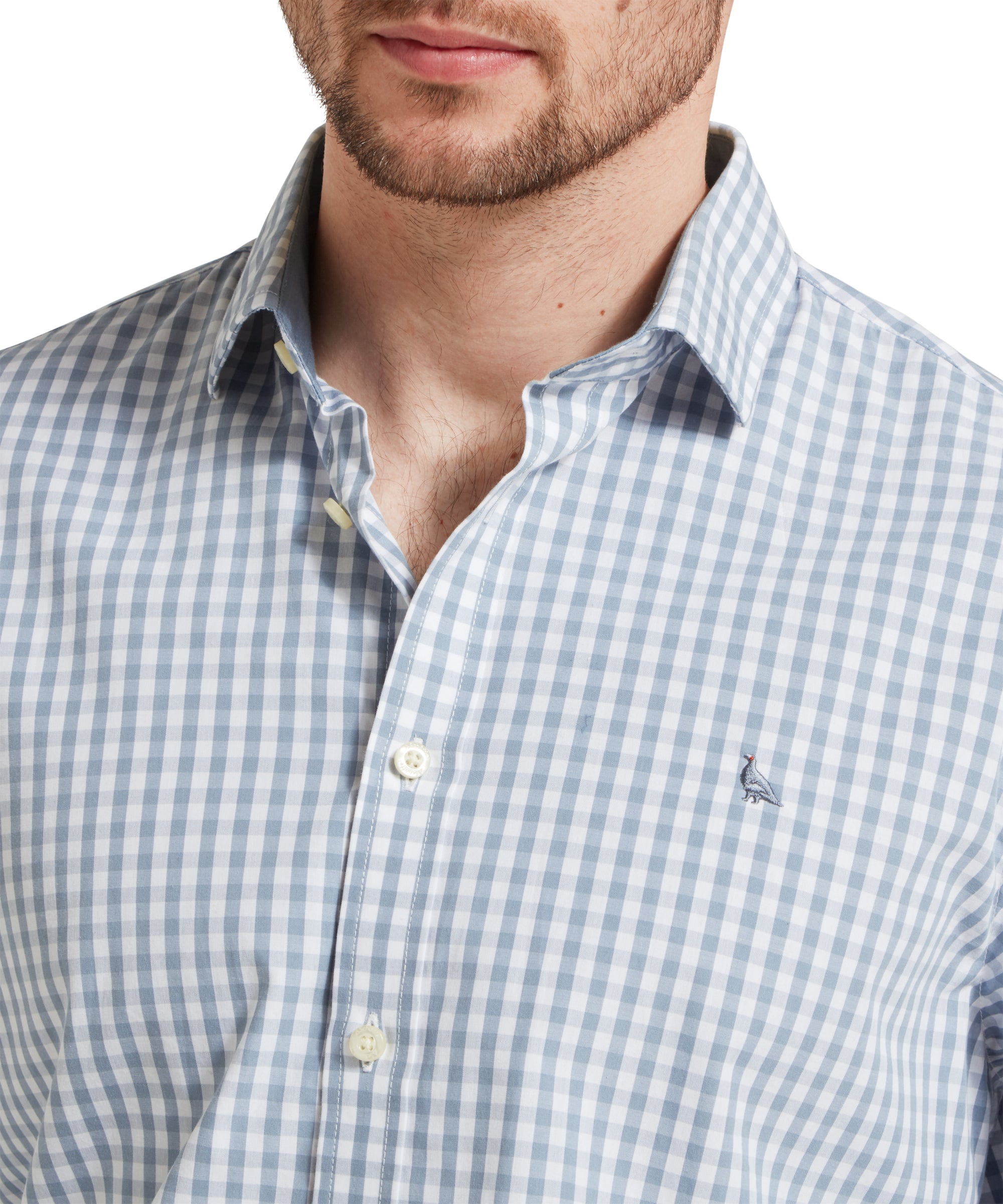 A close-up of the Schöffel Thorpeness Tailored Shirt for Men in Blue, focusing on the embroidered bird logo on the left chest.