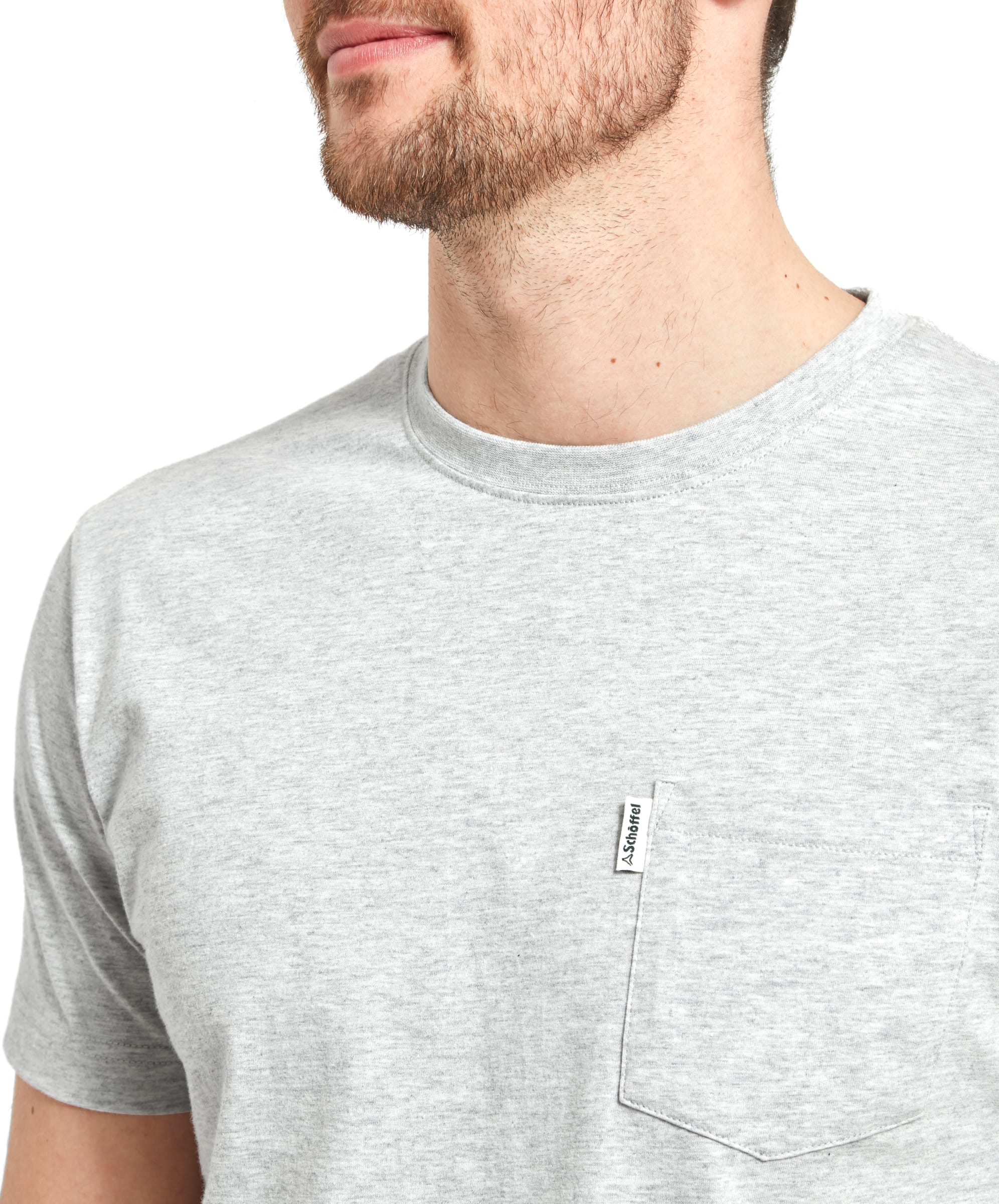 A close-up of the Schöffel Towan T-Shirt for Men in Grey, highlighting a small pocket on the left side of the chest with a subtle brand tag. The neckline of the t-shirt is round, and the fabric has a soft, casual texture.