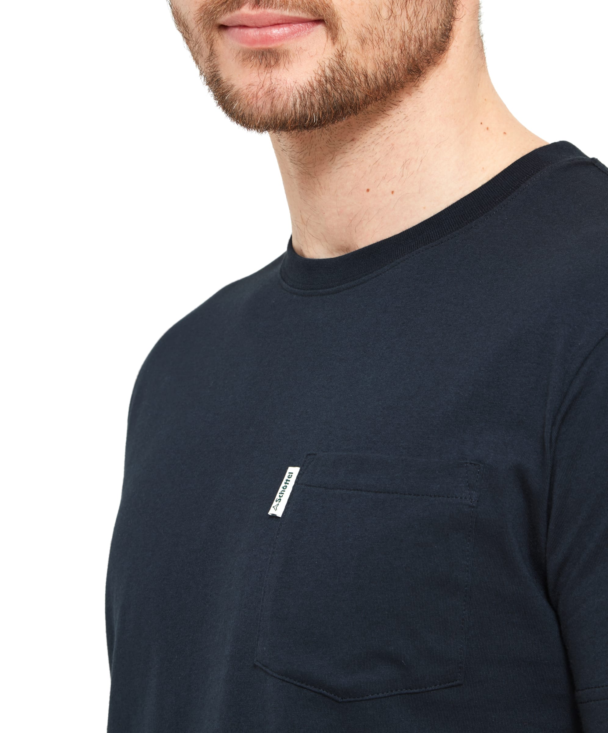 Close-up detail of the Schöffel Towan T-Shirt for Men in Navy, focusing on the chest pocket. The brand's small white tag is visible above the pocket, providing a subtle design detail.