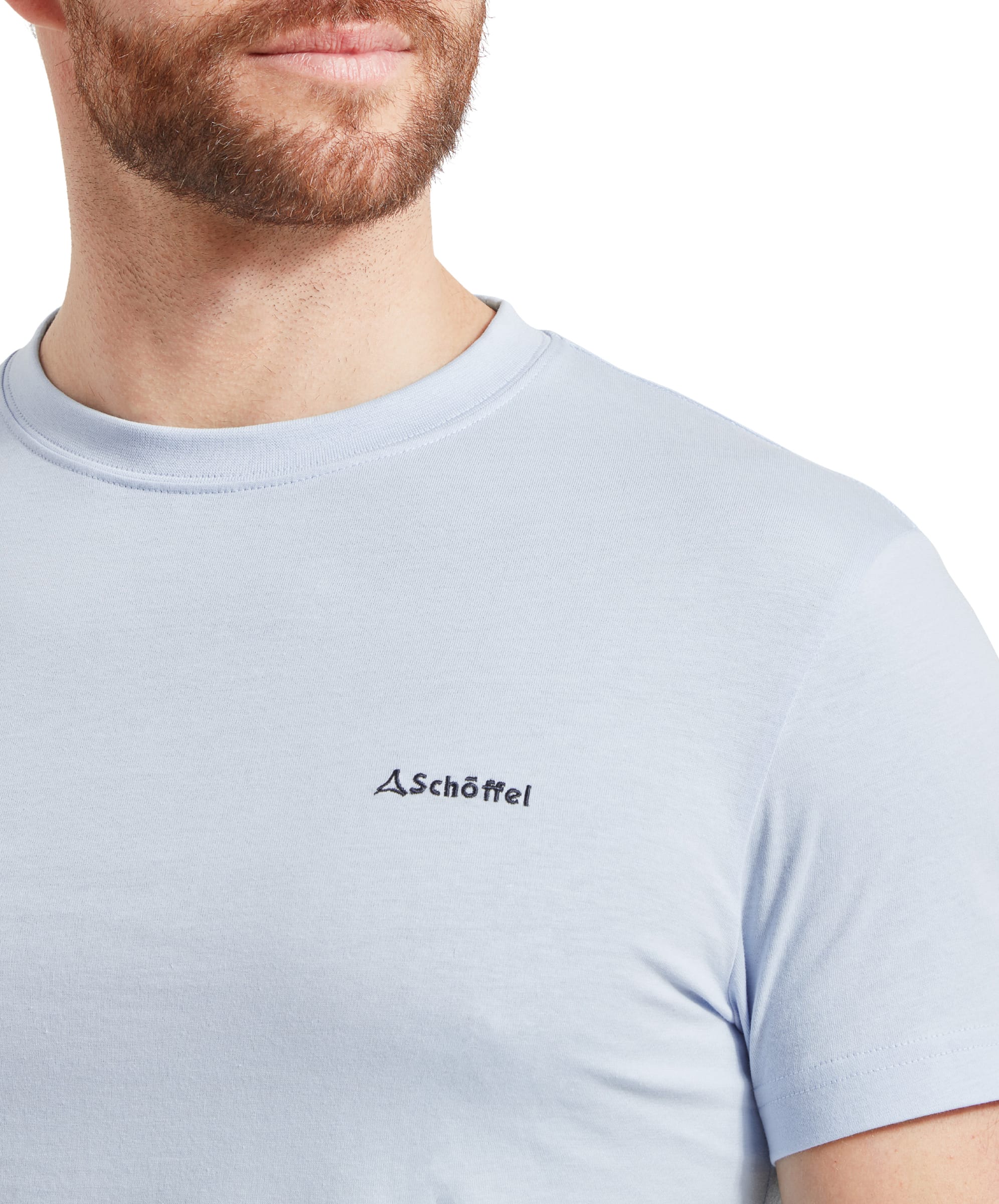 A close-up of the chest area of the Schöffel Trevone T-Shirt for Men in Blue, featuring the brand's embroidered logo.