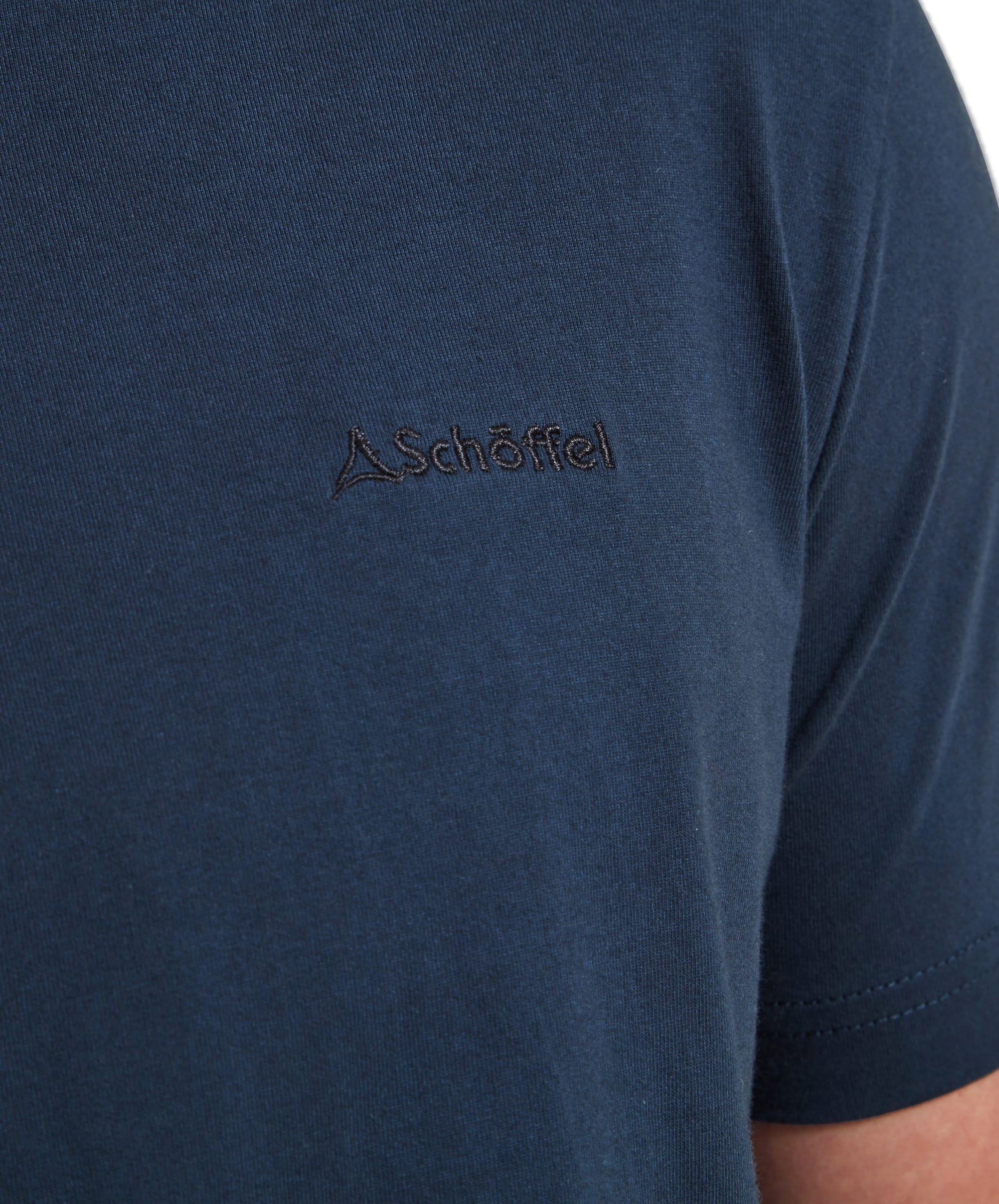 Close-up of the Schöffel Trevone T-Shirt for Men in Navy showing the embroidered Schöffel logo in black on the chest.