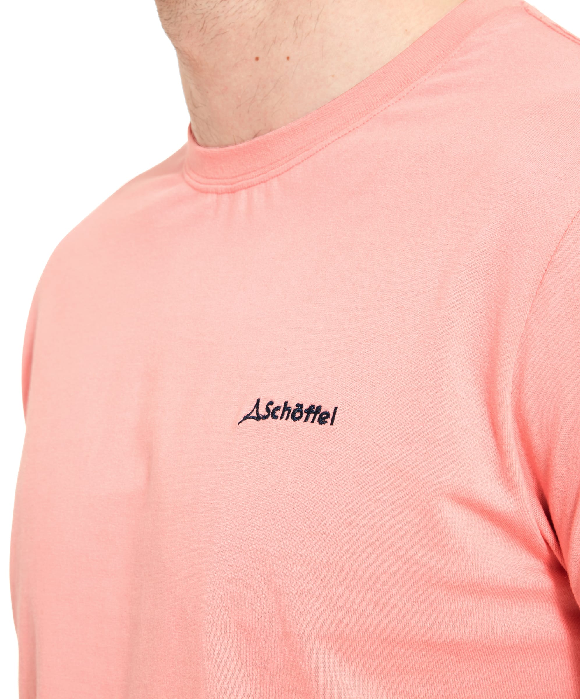 Close-up of the "Schöffel" logo on the left chest of the Schöffel Trevone T-Shirt for Men in Pink, highlighting the embroidery detail.