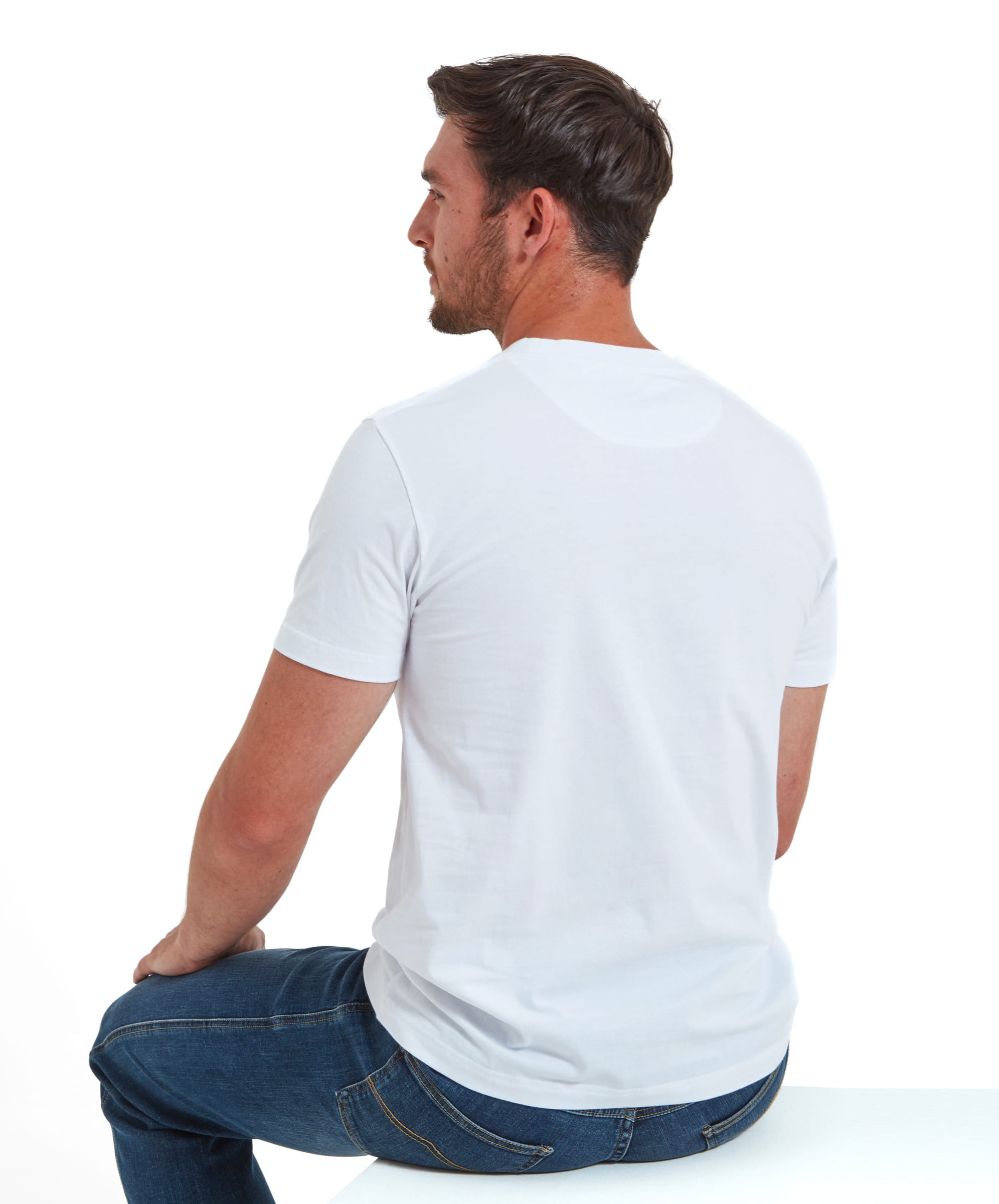 Back view of the model seated, displaying the Schöffel Trevone T-Shirt for Men in White's back.