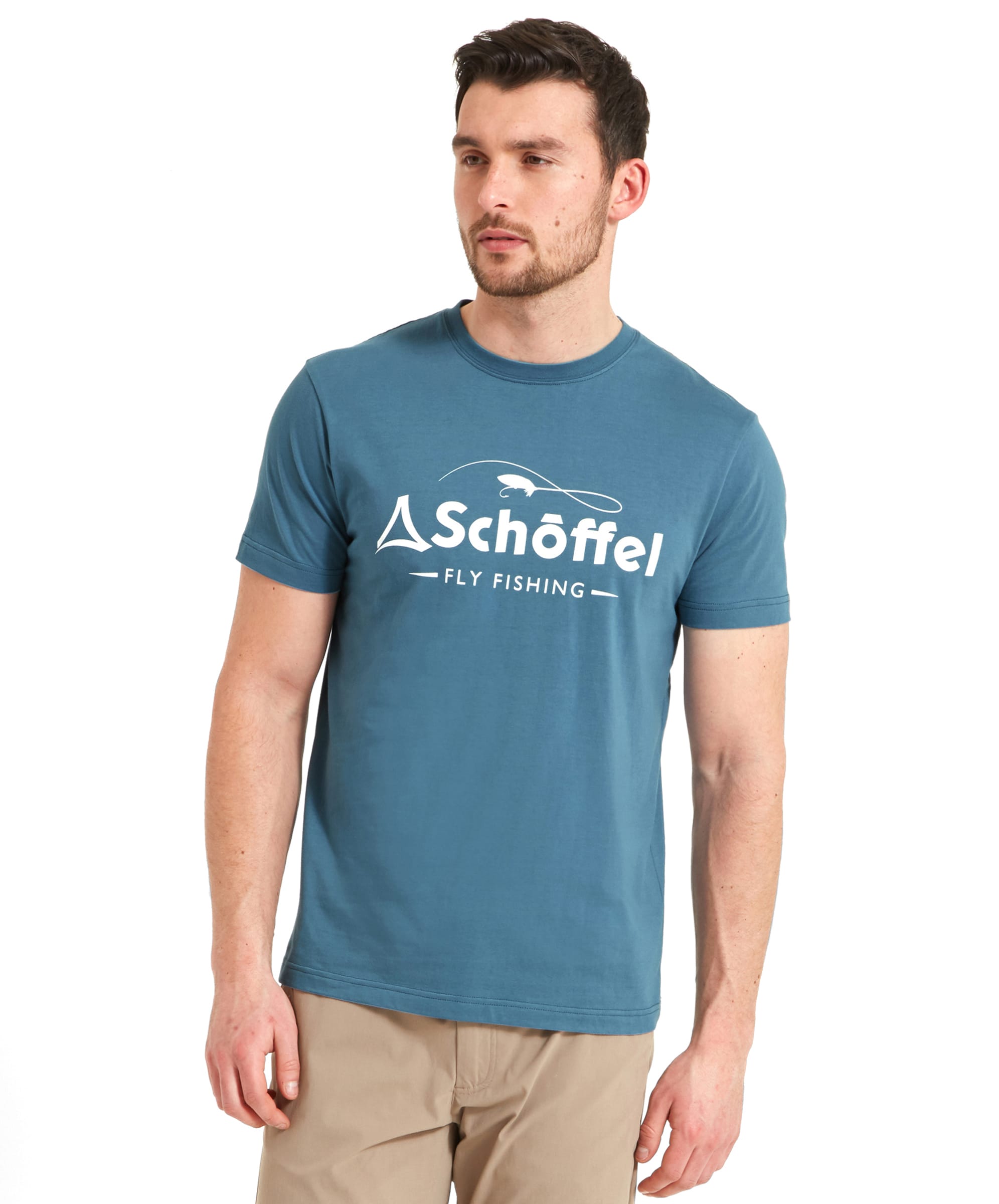 A man wearing a Schöffel Tyne T-Shirt for Men in Blue with "Fly Fishing" and the brand's logo printed on the front. He is standing with his hands by his sides, looking straight ahead.