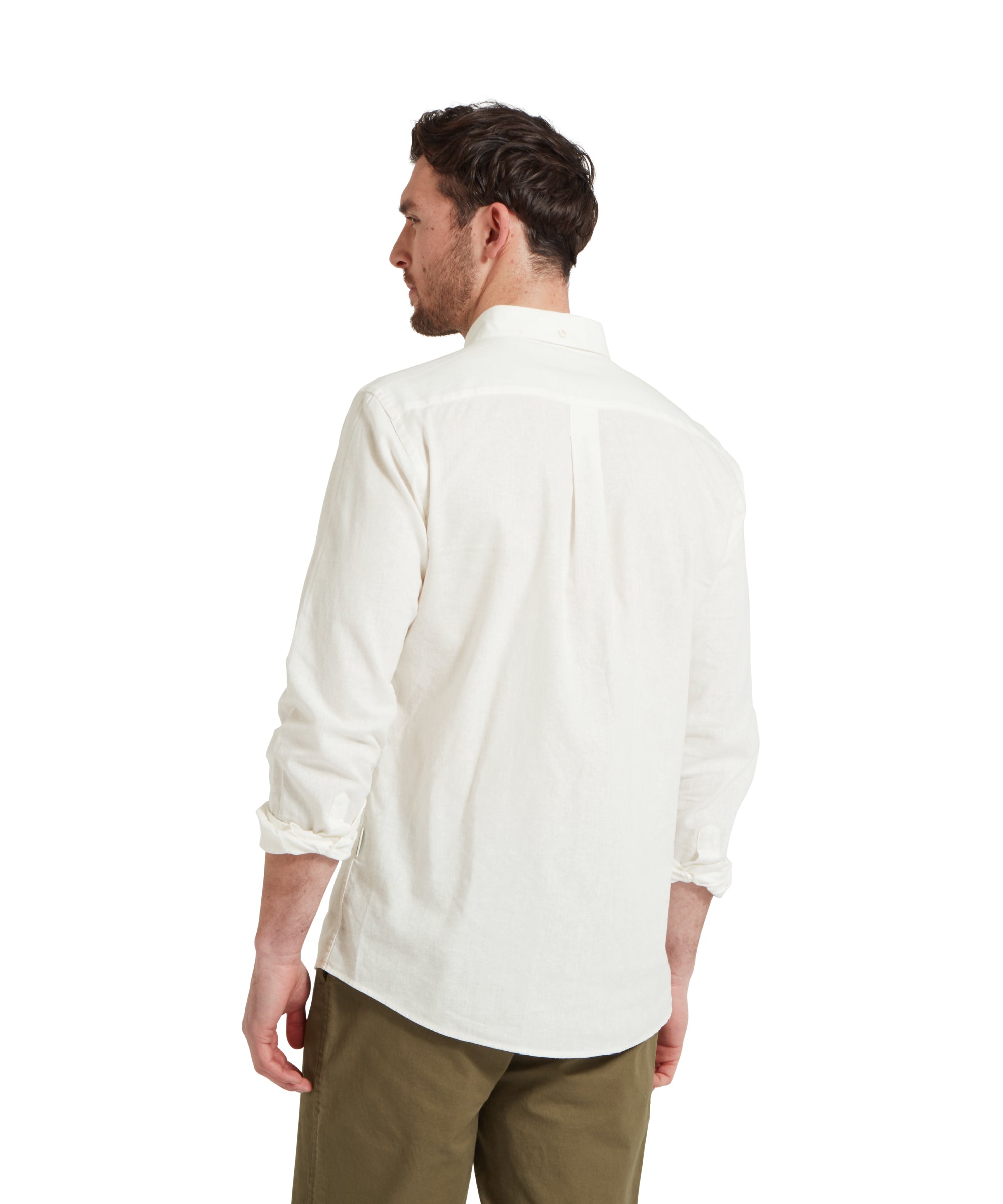 Back image of a male model wearing a white Schöffel shirt paired with dark green chinos trousers. He is standing in a relaxed pose with his hands by his side.