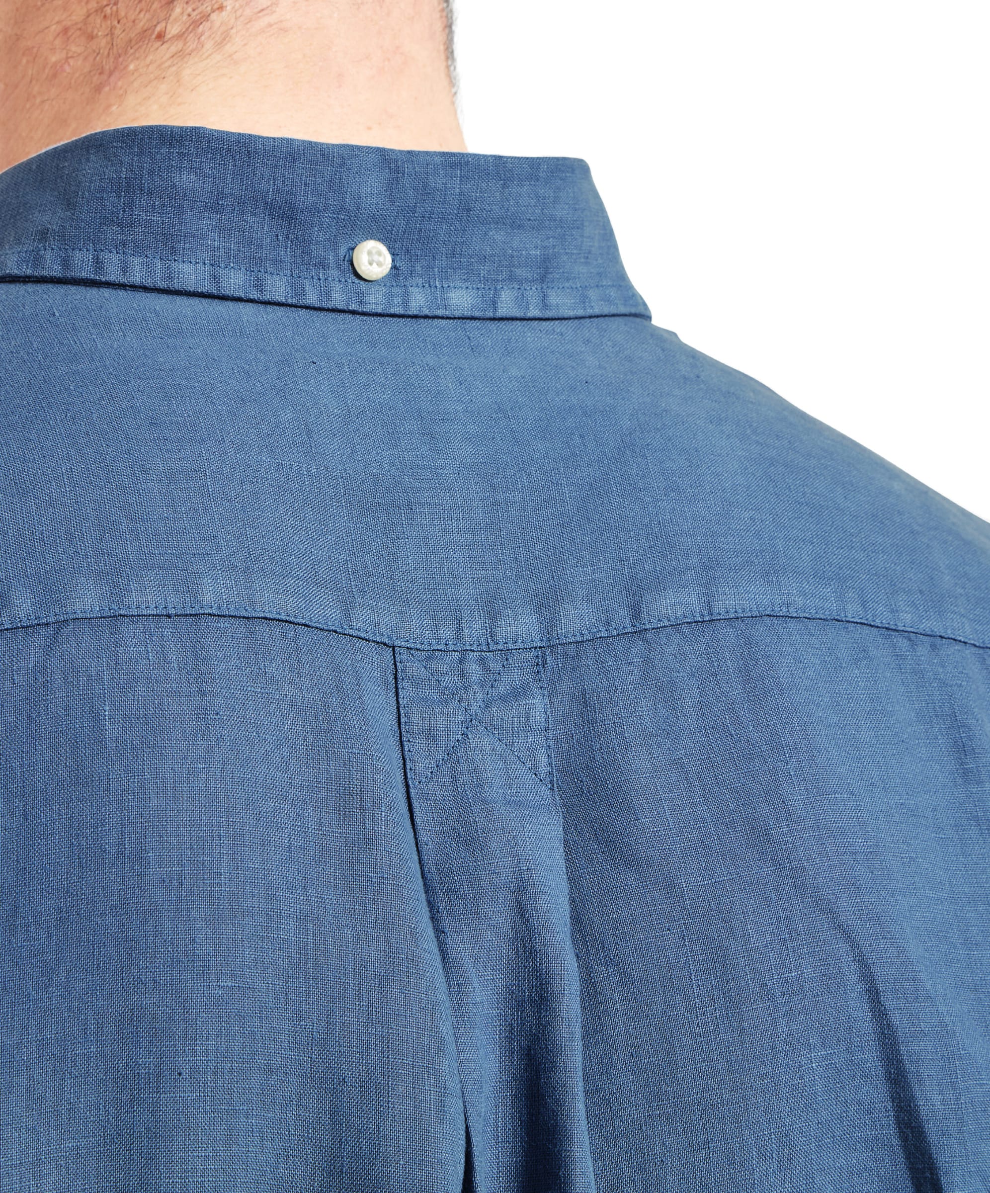 A close-up of the Schöffel Walsingham Linen Shirt for Men in Blue's back, focusing on the fine details like the button at the collar's back and the neat stitching, showcasing the shirt's quality and style.