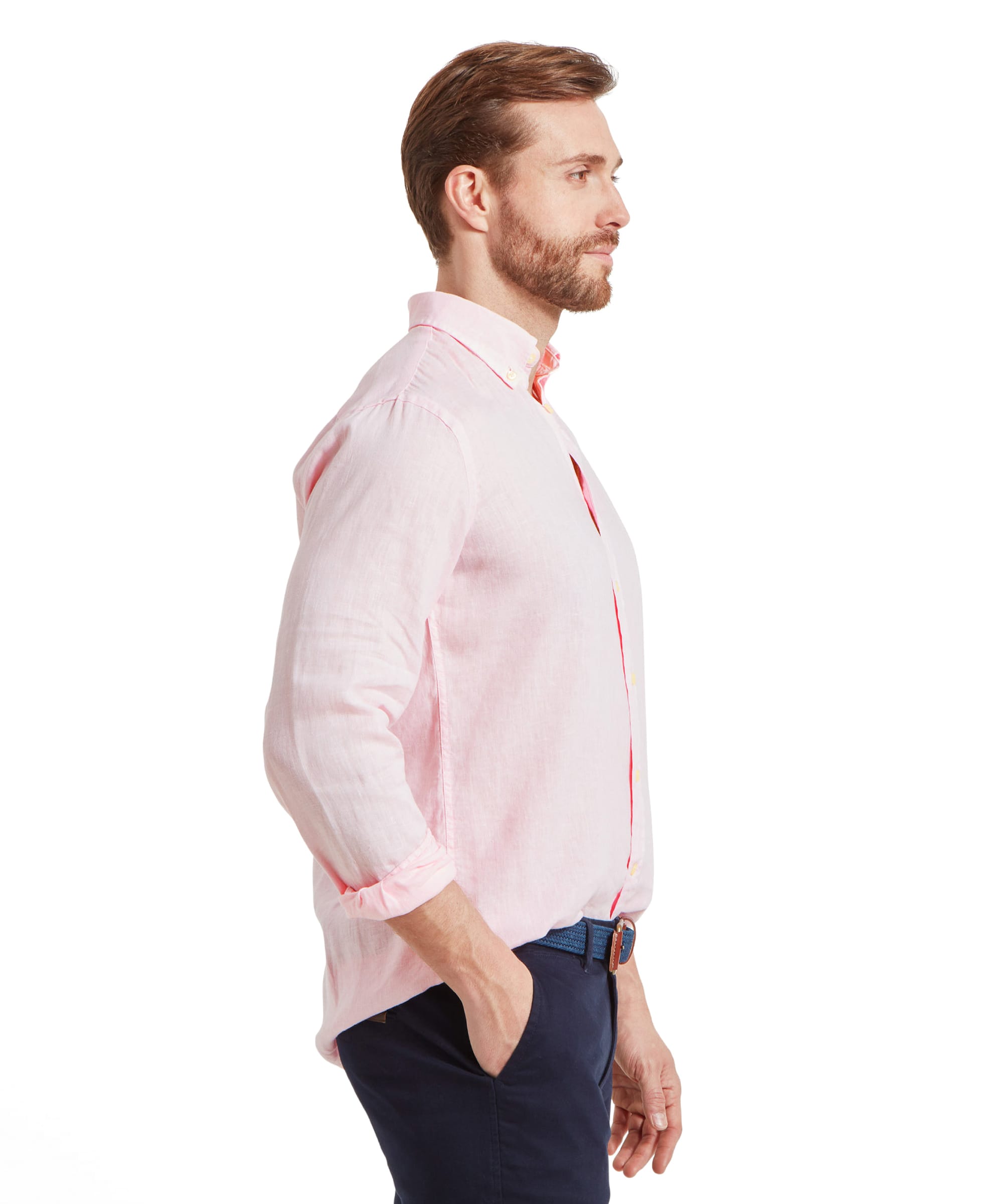 A side profile of the man wearing the Schöffel Walsingham Linen Shirt for Men in Pink, showing the shirt's fit and how it drapes casually. The sleeves are slightly rolled up, adding to the relaxed, comfortable style.