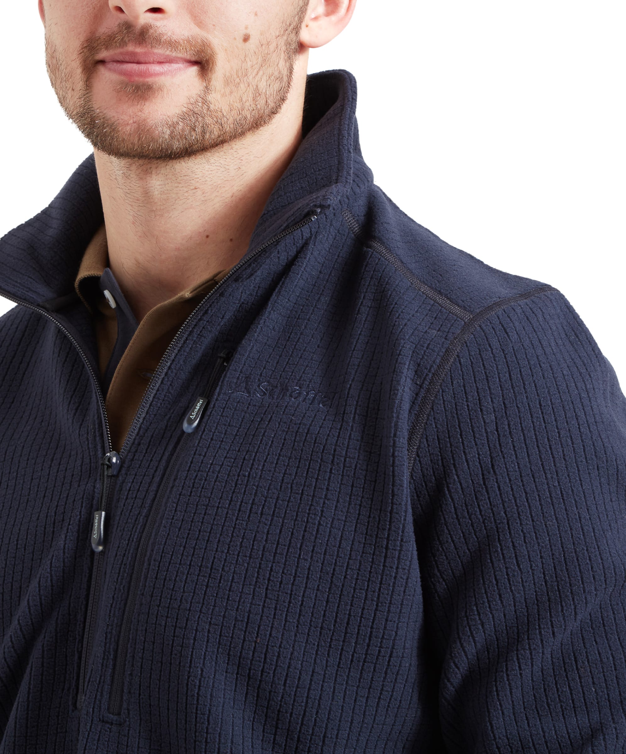 A close-up of the Schöffel Welland Lightweight Fleece for Men in Blue shows the textured, ribbed pattern and the half-zip collar design. The brand logo is subtly embroidered on the chest, and the model's facial expression is neutral. This detail shot focuses on the quality and design elements of the fleece.