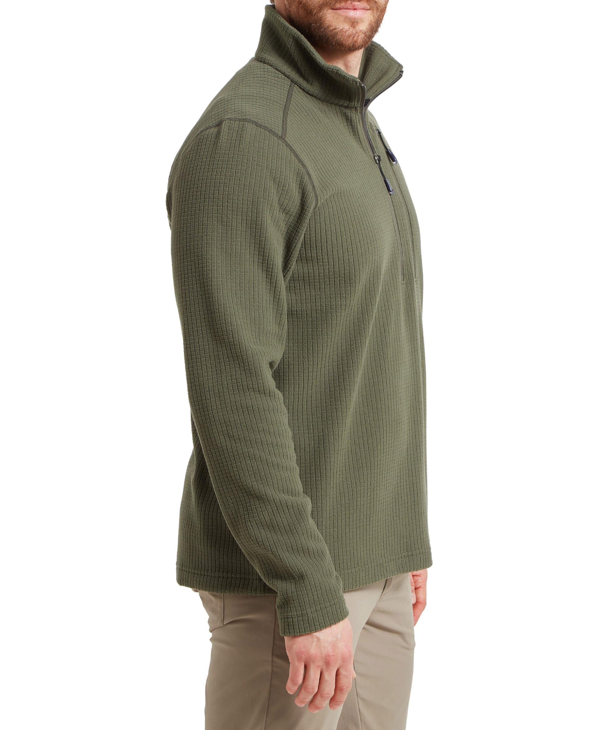 A side view of the model wearing the Schöffel Welland Lightweight Fleece for Men in Green shows the garment's texture and fit. The model's hand rests on his leg, highlighting the fleece's relaxed and functional design.