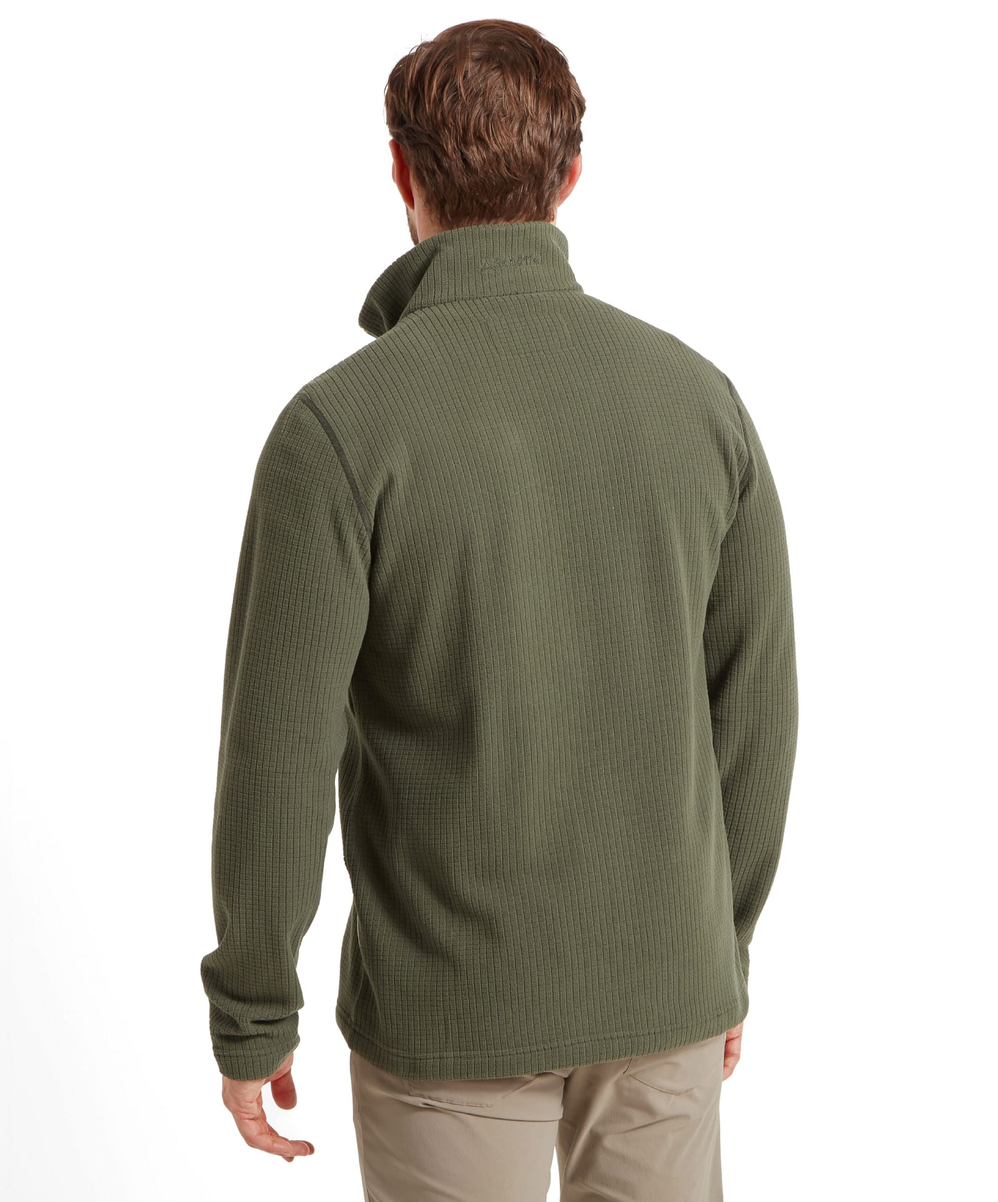 The image captures the back of the Schöffel Welland Lightweight Fleece for Men in Green, emphasizing its smooth and simple finish. The model's stance shows the comfortable fit of the garment.