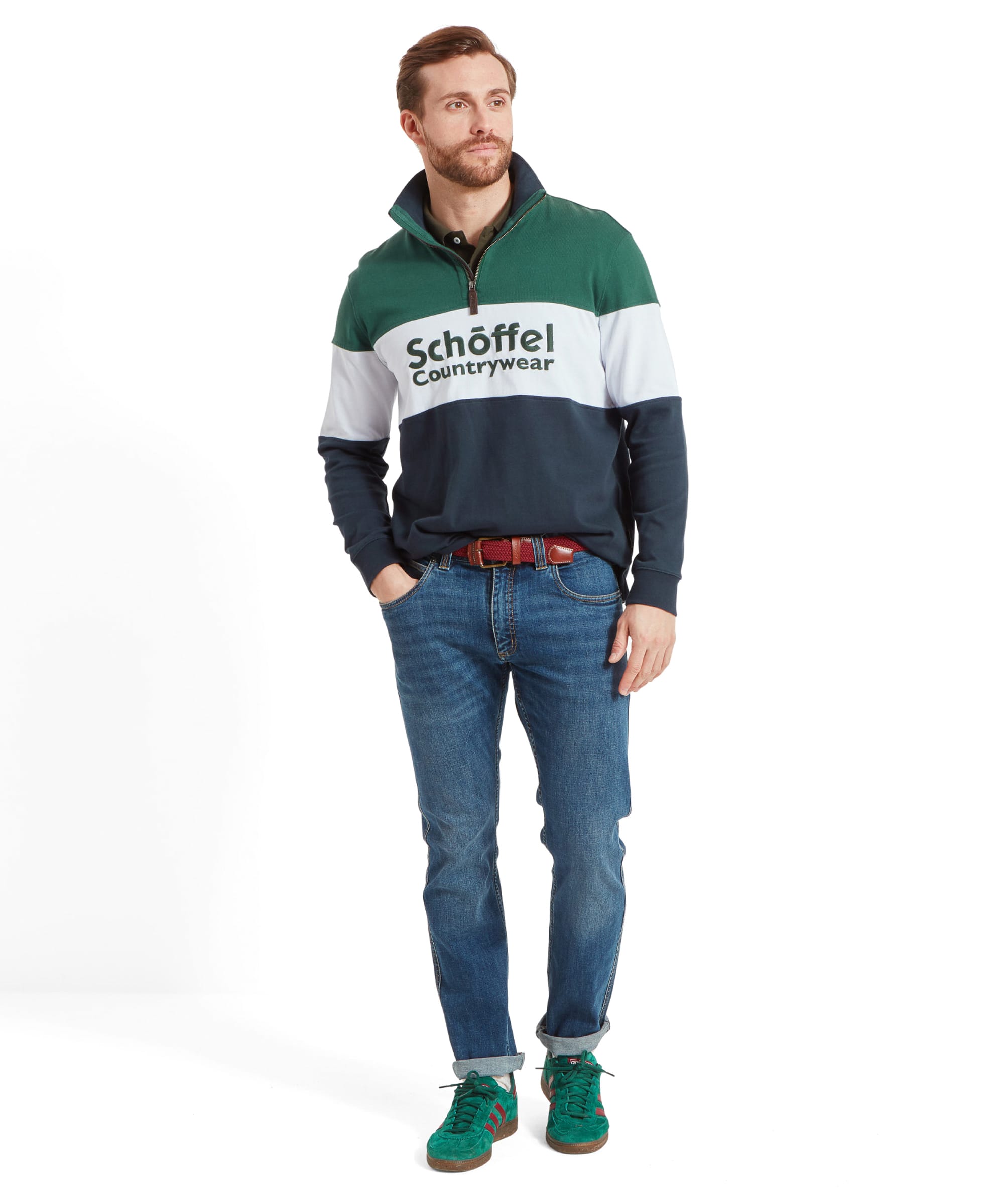 Full-body image of a man in the Schöffel quarter-zip sweatshirt, paired with jeans and green sneakers, standing in a relaxed pose.