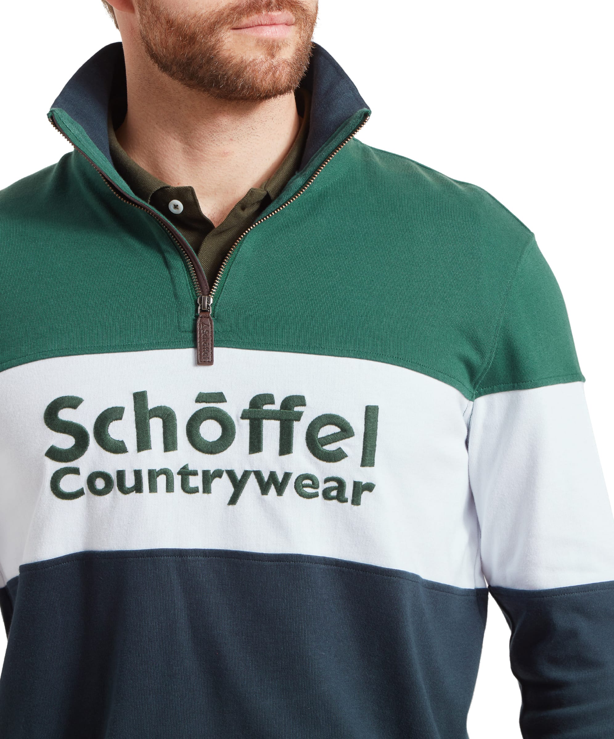 Detailed view of the Schöffel Exeter Heritage 1/4 Zip for Unisex in Navy logo embroidered in green on the chest of the quarter-zip sweatshirt.