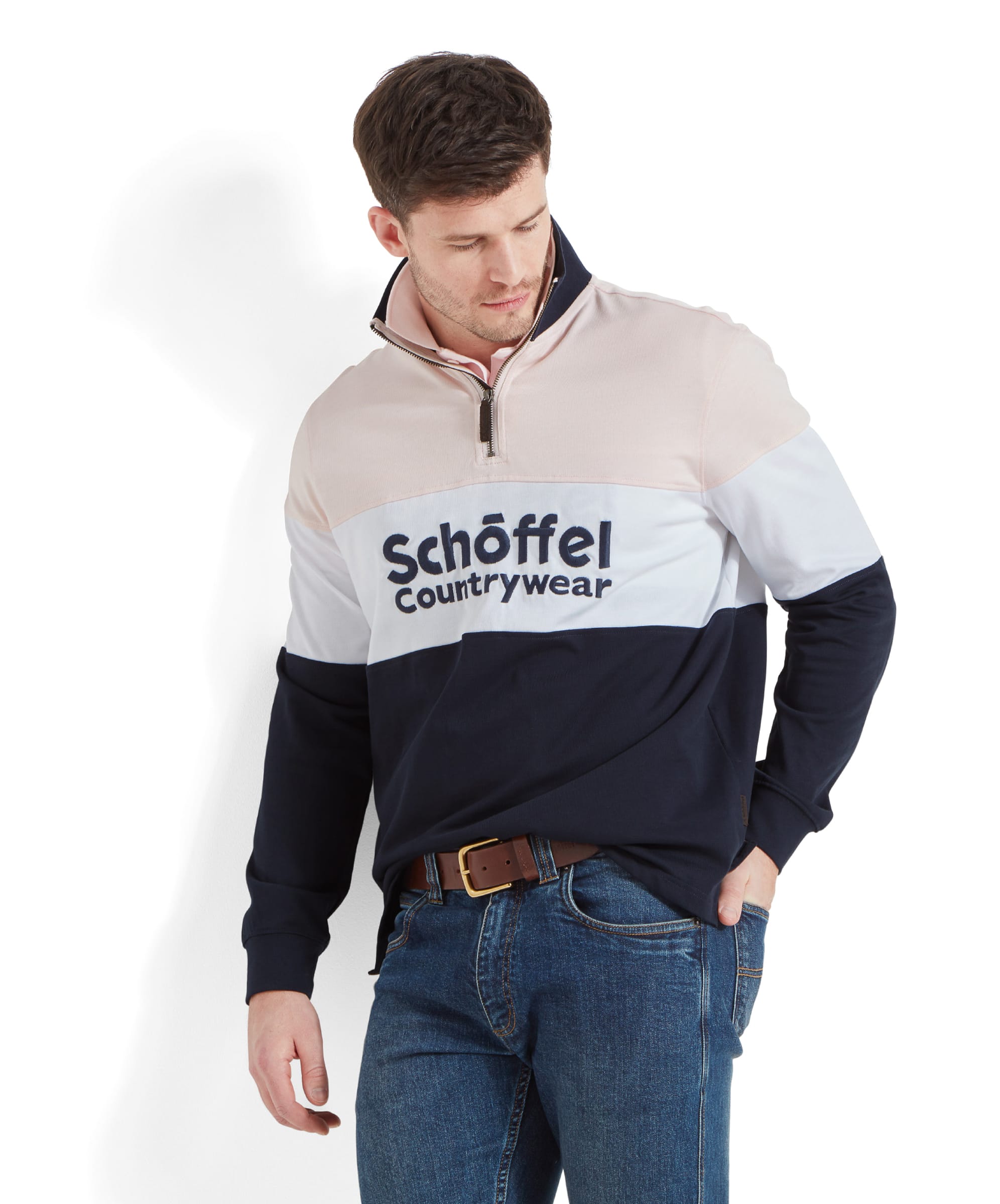 A man is wearing a Schöffel Exeter Heritage 1/4 Zip for Unisex in Pale Pink with "Schöffel Countrywear" embroidered on the chest. He is looking to his left.