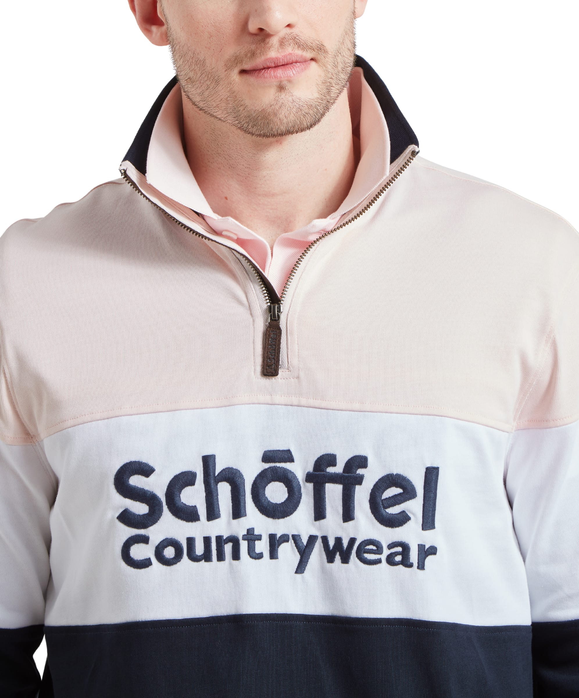 Close-up of the Schöffel Exeter Heritage 1/4 Zip for Unisex in Pale Pink's logo on the chest.