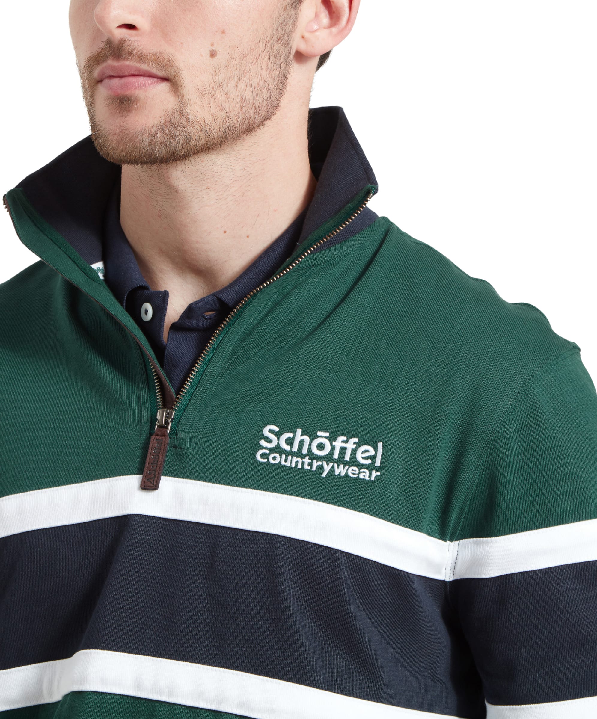 A close-up of the Schöffel Exmouth Heritage 1/4 Zip for Unisex in Green, focusing on the Schoffel Countrywear logo on the left chest, the zipper, and the collar details.