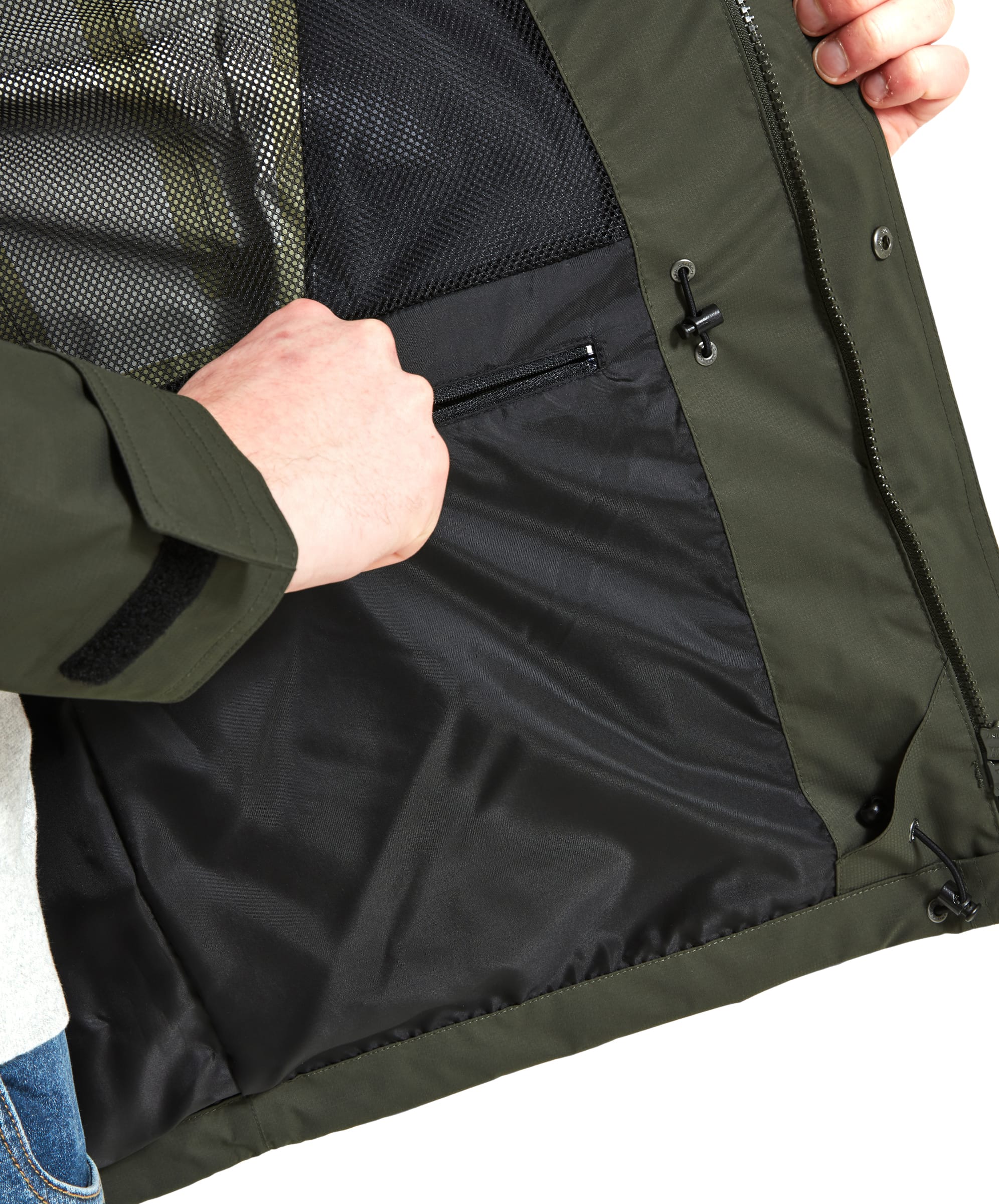 Close-up of the inside of the Schöffel Unisex Ketton Jacket II in Green, with the man holding the jacket open to reveal the internal mesh pocket and the fabric texture.