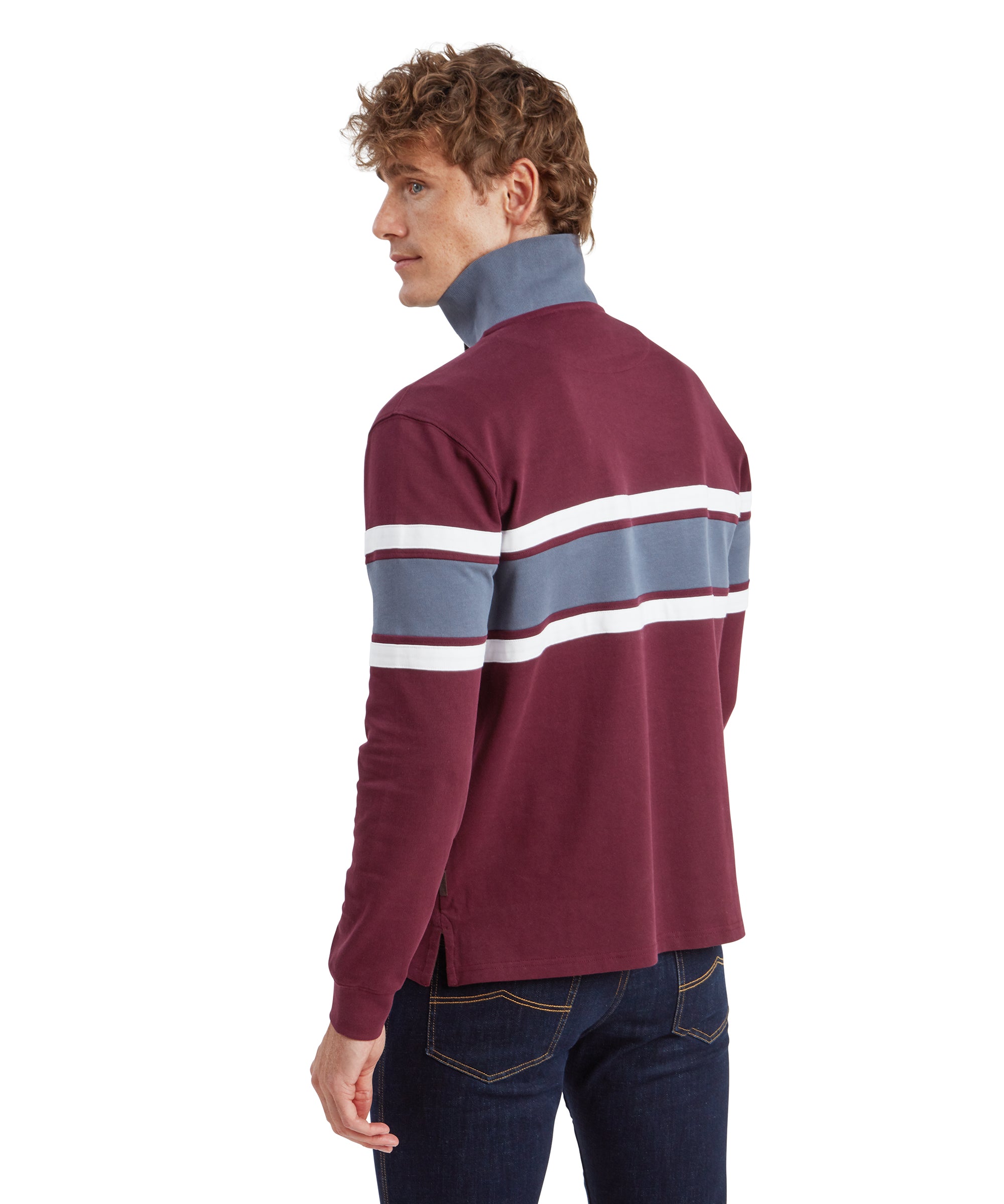 Back view of a man wearing the Schöffel Exmouth Heritage 1/4 Zip for Unisex in Red with the collar popped up. He peers over his left shoulder.