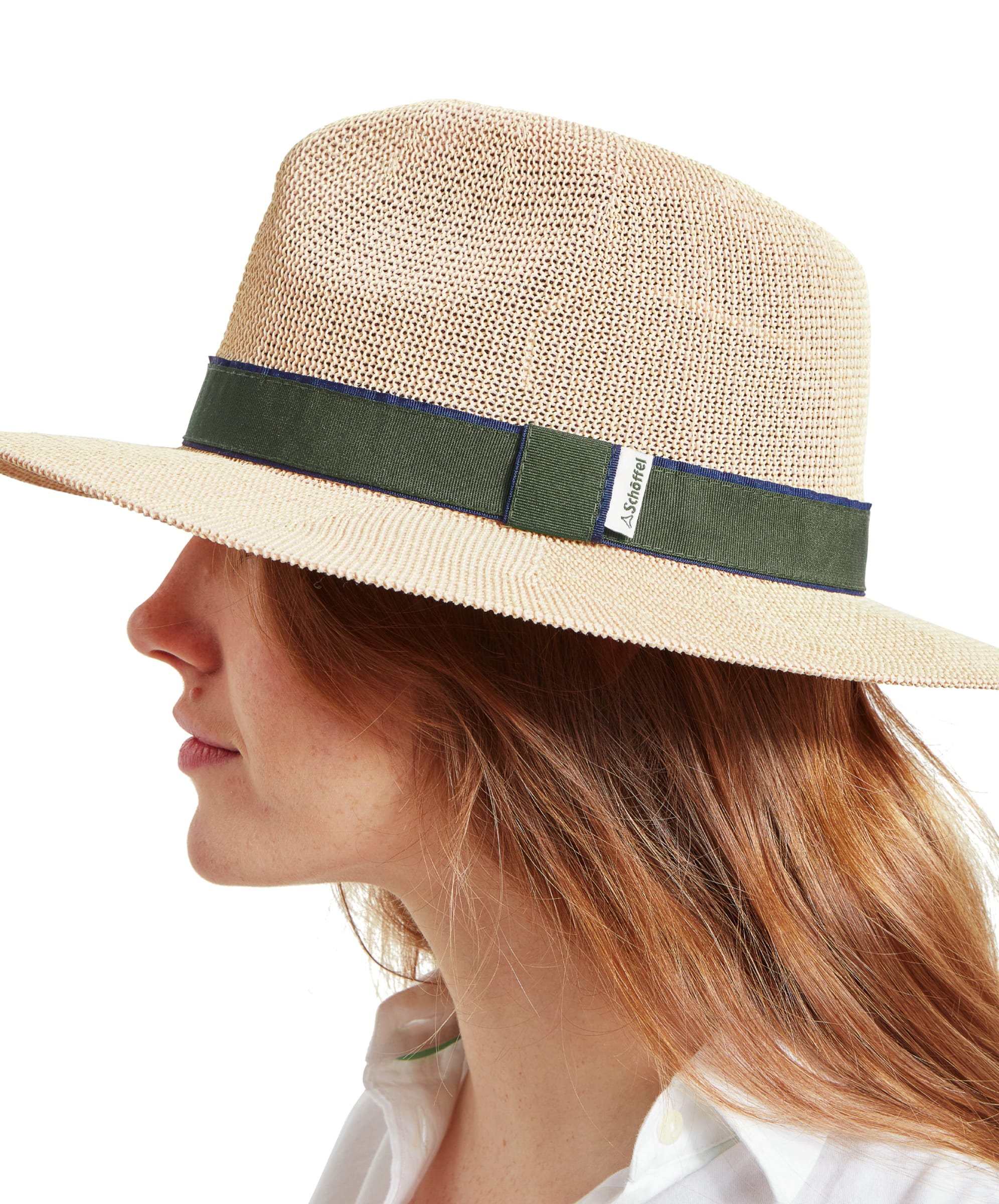 A side view of a woman wearing a Schöffel Unisex Porth Hat in Green, highlighting the hat's texture and the Schöffel brand tag on the band.