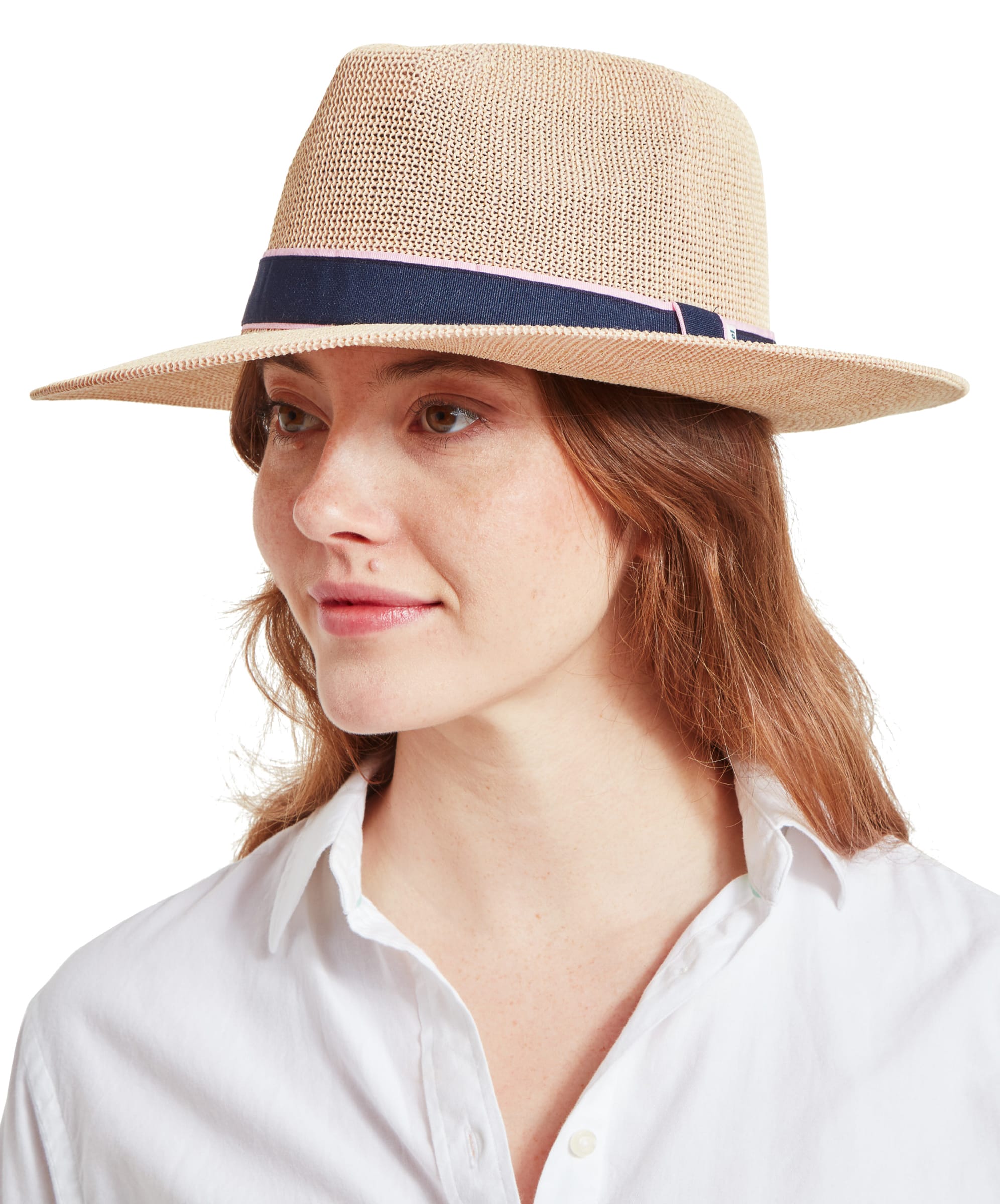 A woman with auburn hair wears a Schöffel Unisex Porth Hat in Blue and Pink, smiling softly.