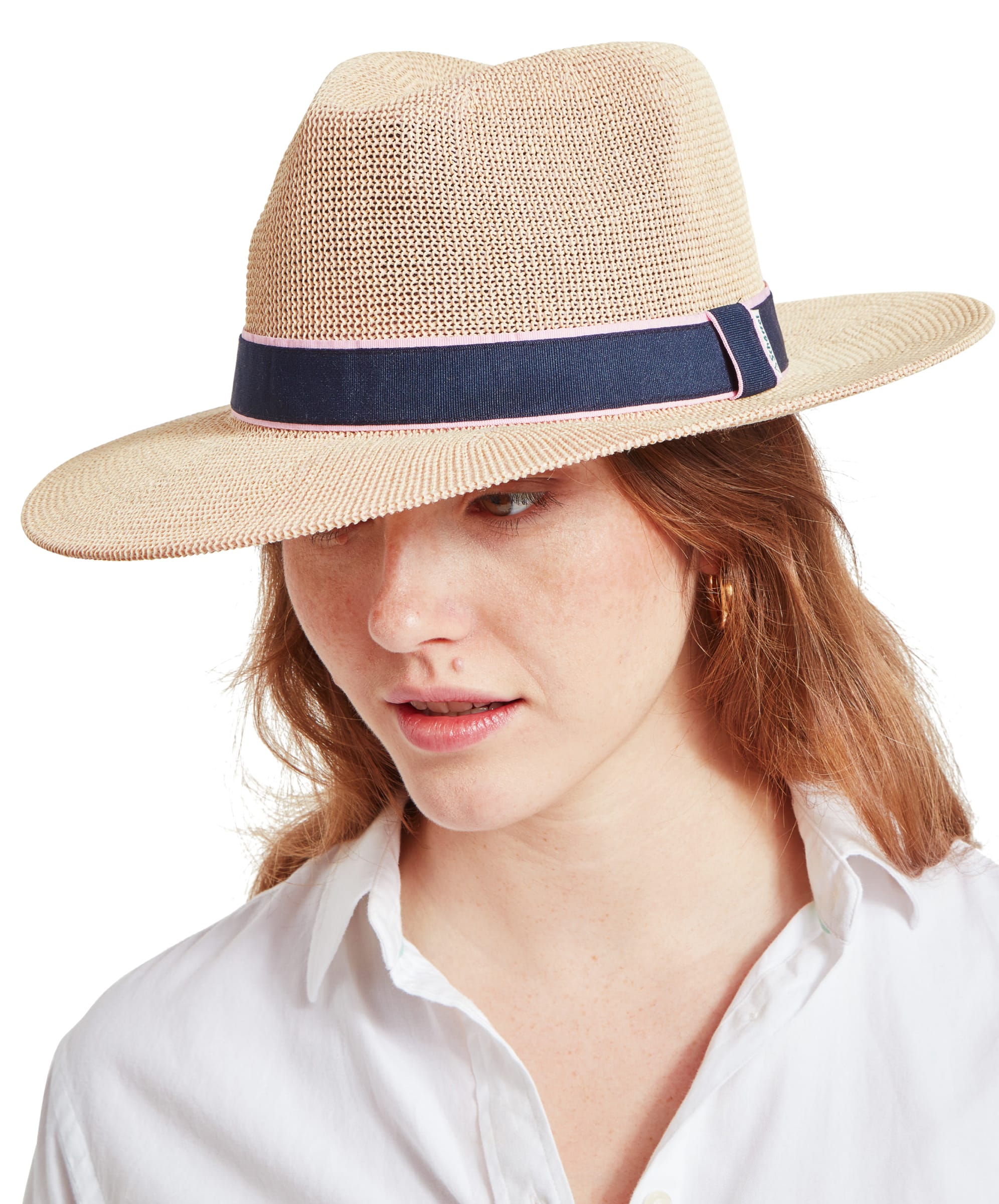 A woman with auburn hair wears a Schöffel Unisex Porth Hat in Blue and Pink, gazing slightly to the side with a neutral expression.