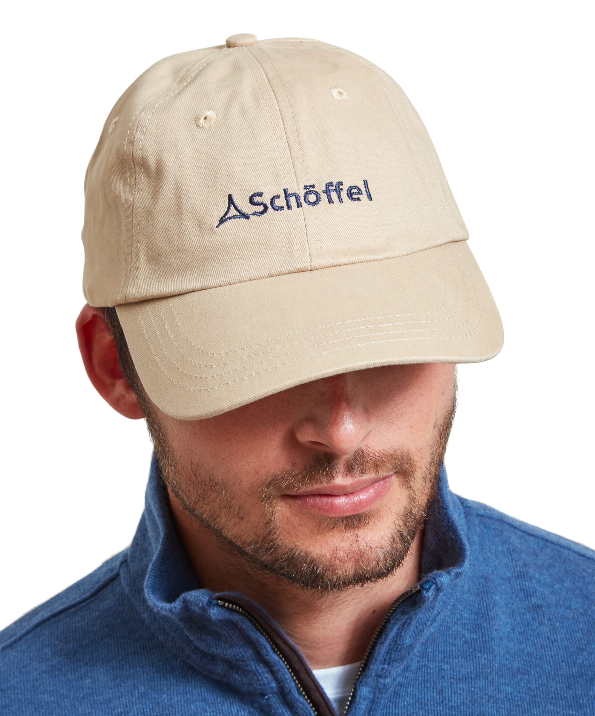 Front view of a man wearing a Schöffel Unisex Thurlestone Cap in Light Brown with the Schöffel logo embroidered in navy blue on the front panel.