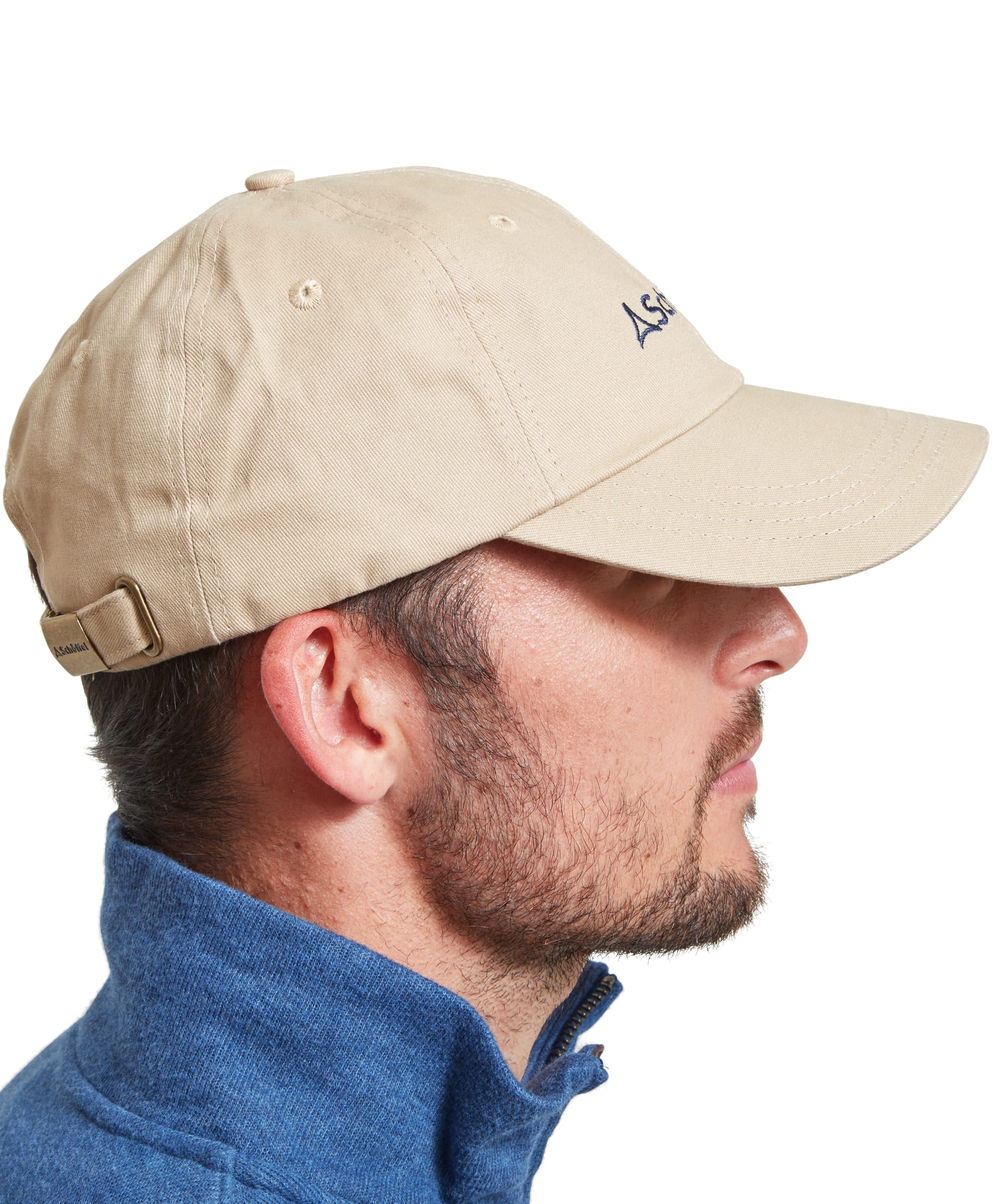 Side profile of a man wearing a Schöffel Unisex Thurlestone Cap in Light Brown, showcasing the cap's adjustable strap and brass buckle.