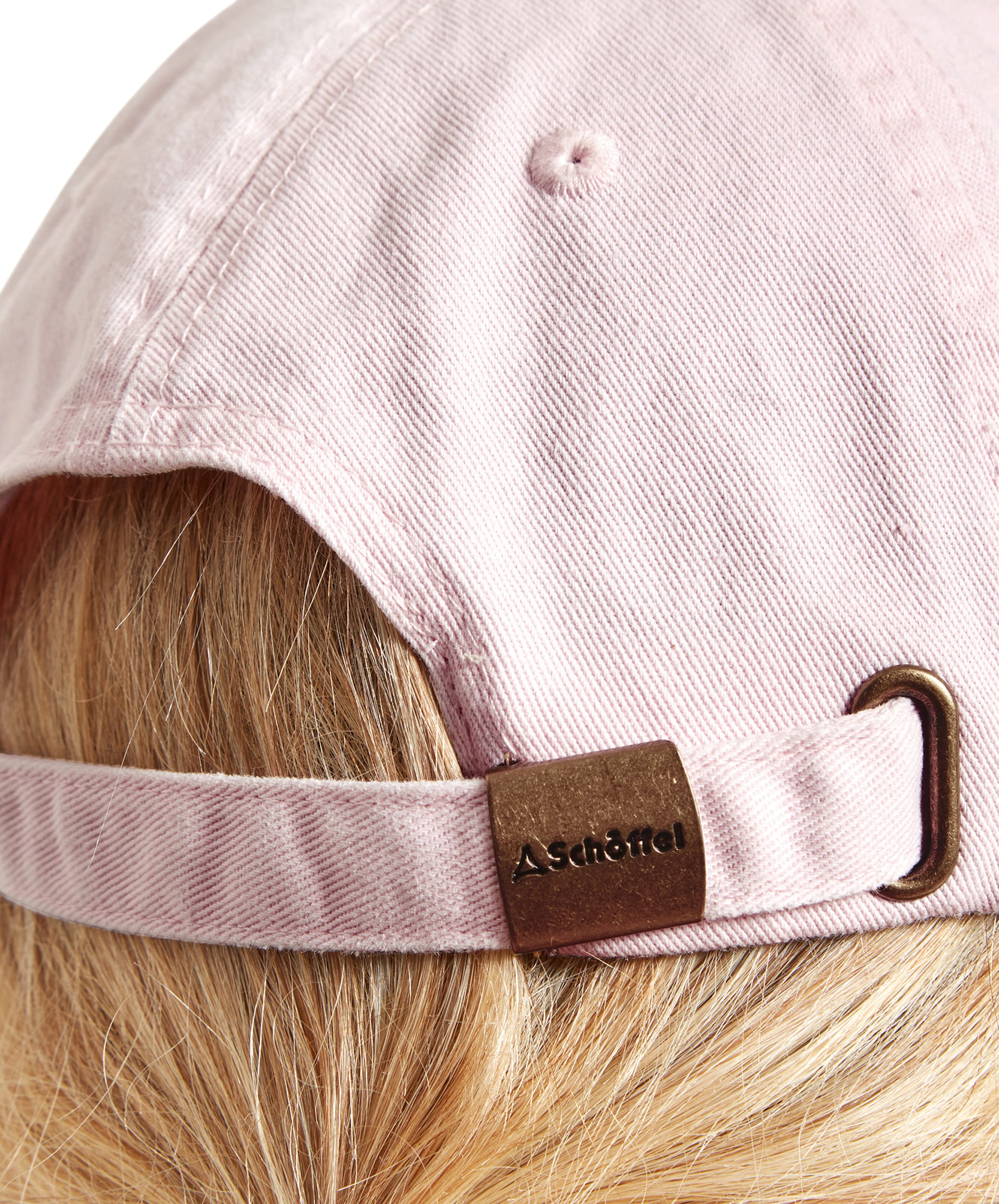 Close-up of the back of a Schöffel Unisex Thurlestone Cap in Pale Pink showing the adjustable strap with a metal clasp engraved with the "Schöffel" logo.