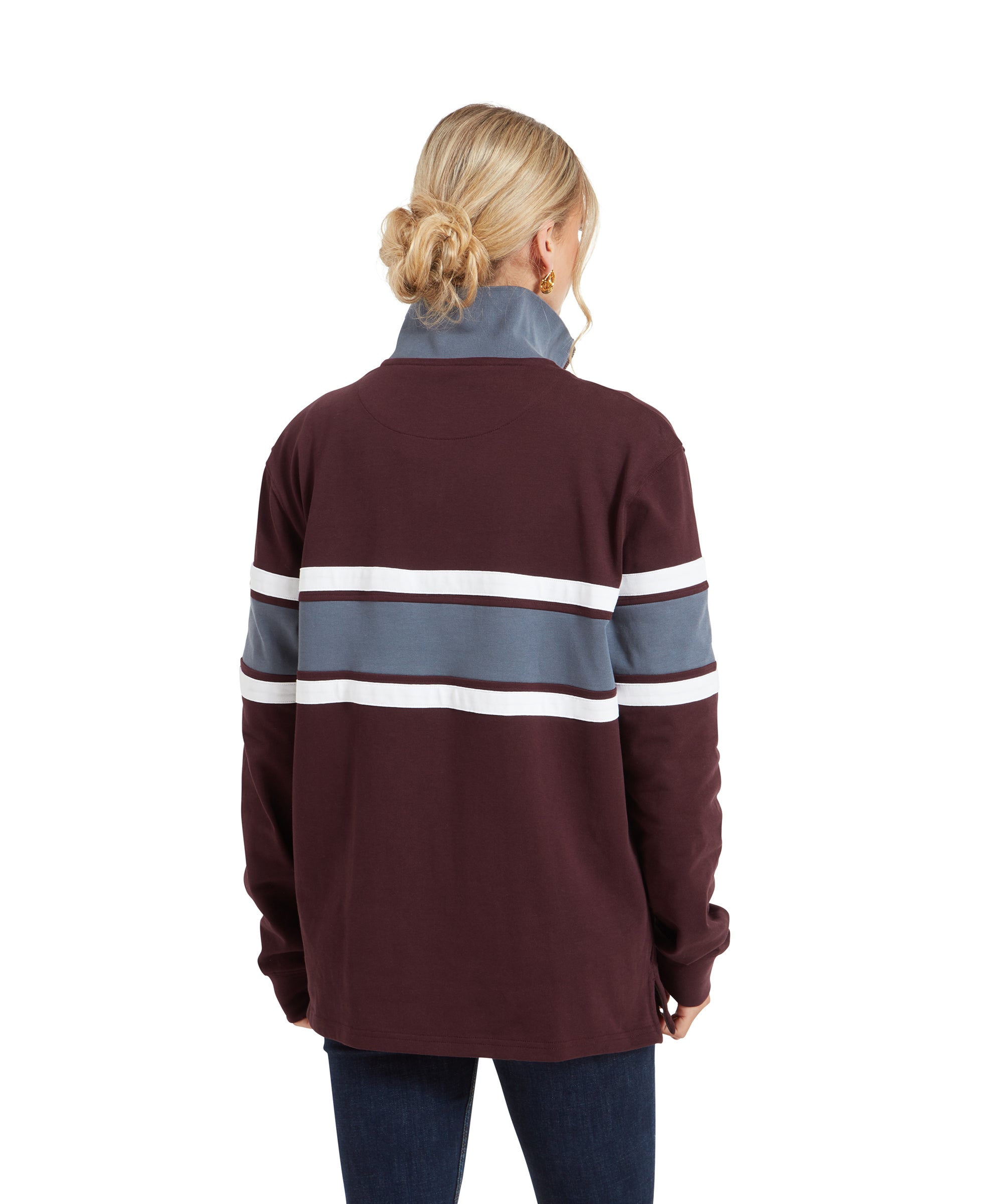 A back view of the Schöffel Exmouth Heritage 1/4 Zip for Unisex in Red, showing the stripes extending across the back and the relaxed fit. The woman's hair is styled in a loose bun.