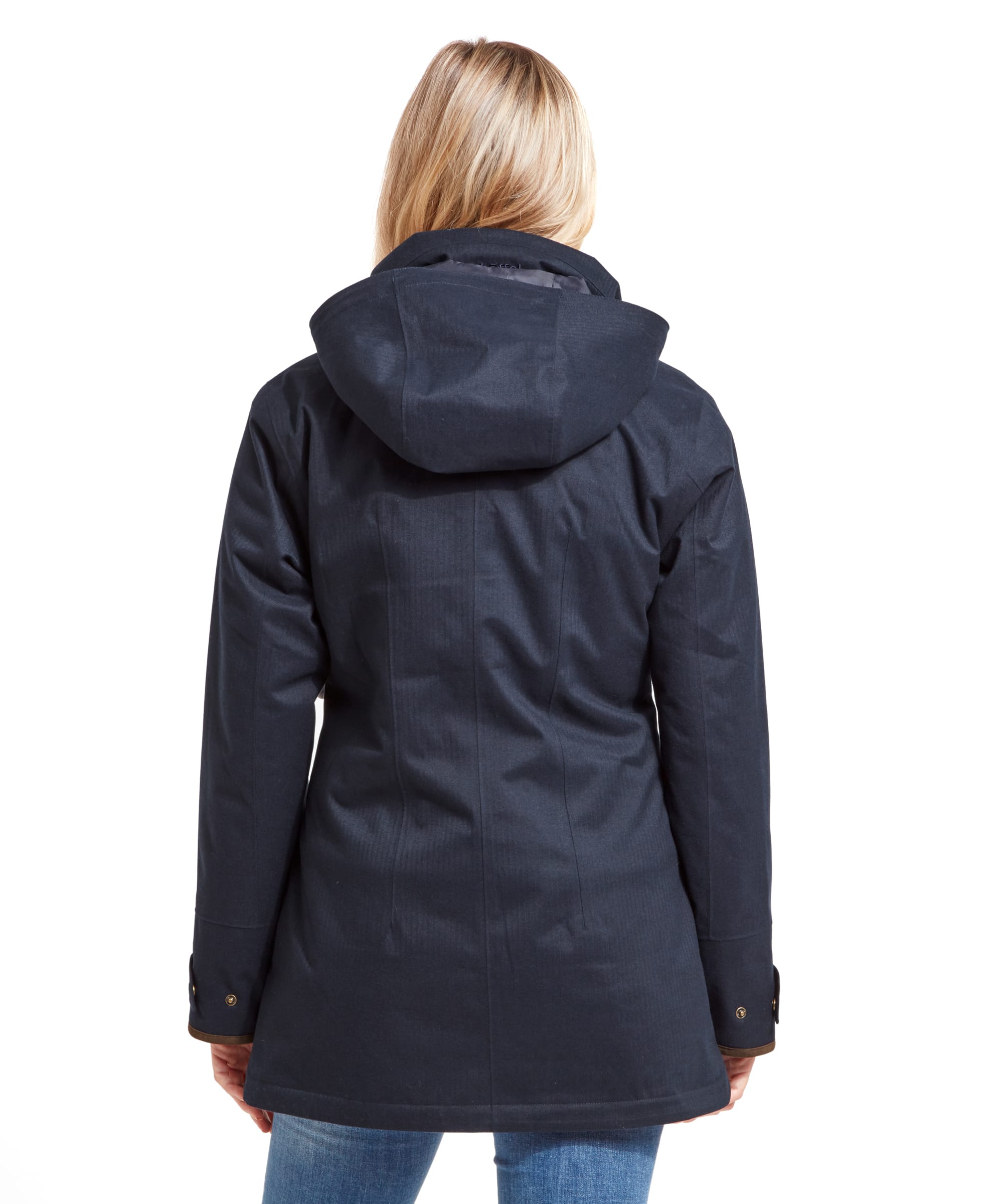 Rear view of the woman wearing the Schöffel Wakerley Jacket for Women in Blue, showing the hood draped down the back. The jacket is slightly tailored, offering a fitted silhouette, and extends to just below the hips. The hood is attached but can be tucked away or adjusted as needed.