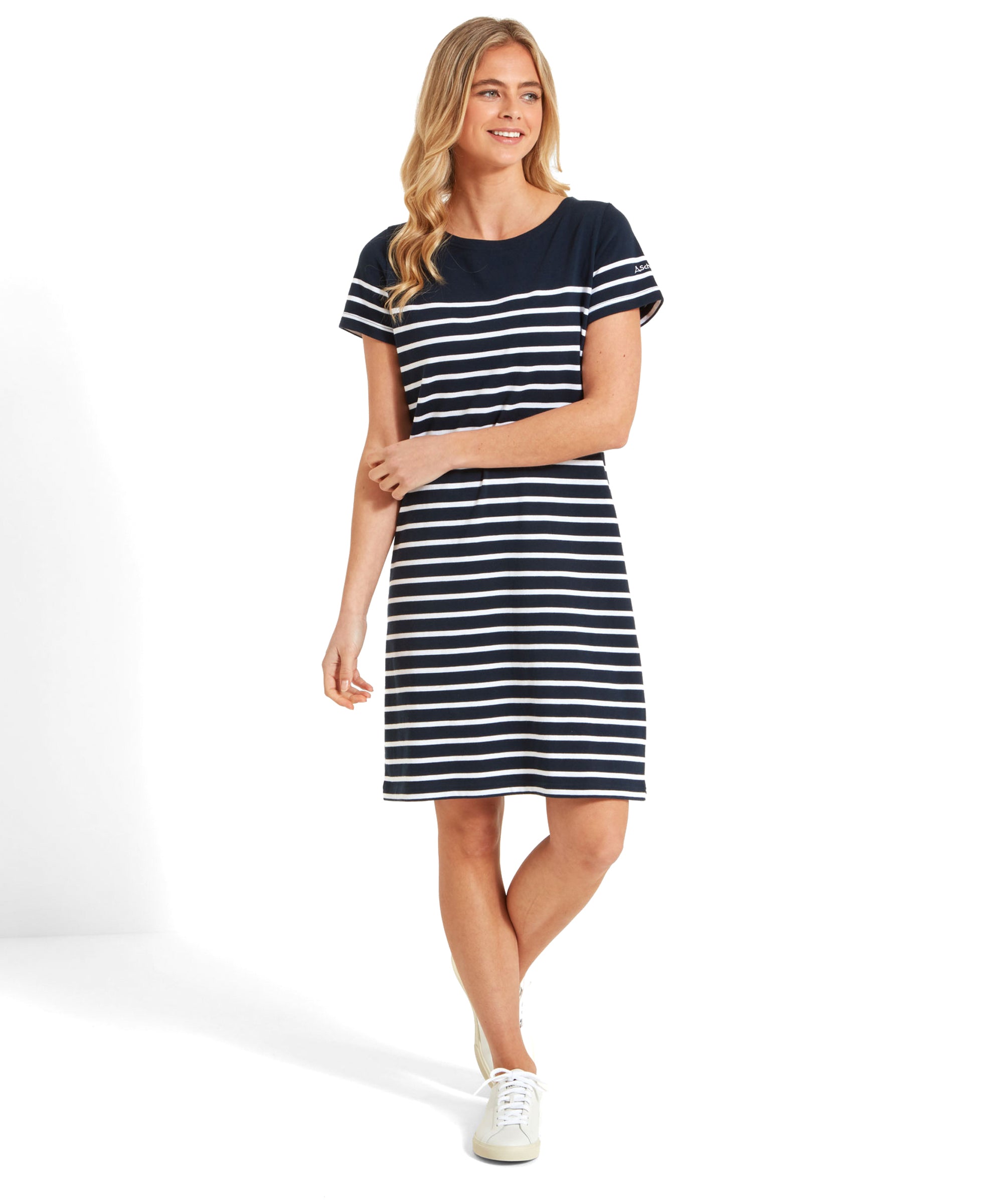 Model in a Schöffel Beauport Dress for Women in Navy standing with a smile, hands relaxed.