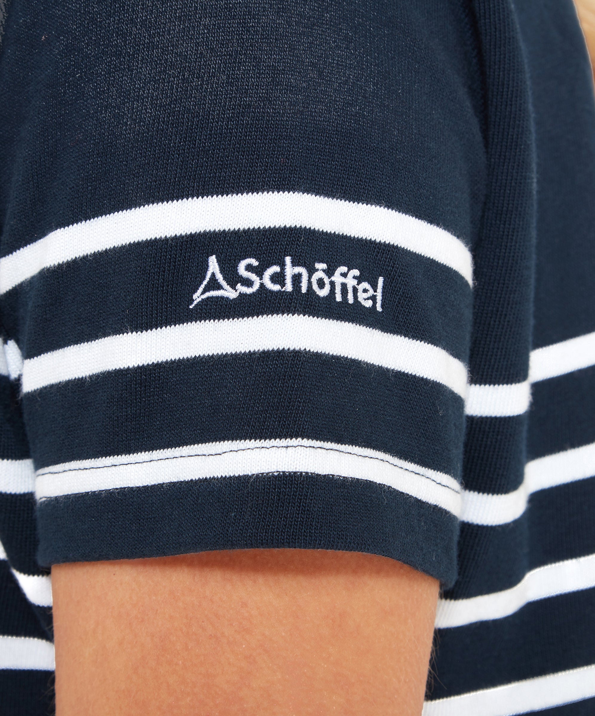 Close-up of the sleeve of the Schöffel Beauport Dress for Women in Navy with the Schöffel logo embroidered.