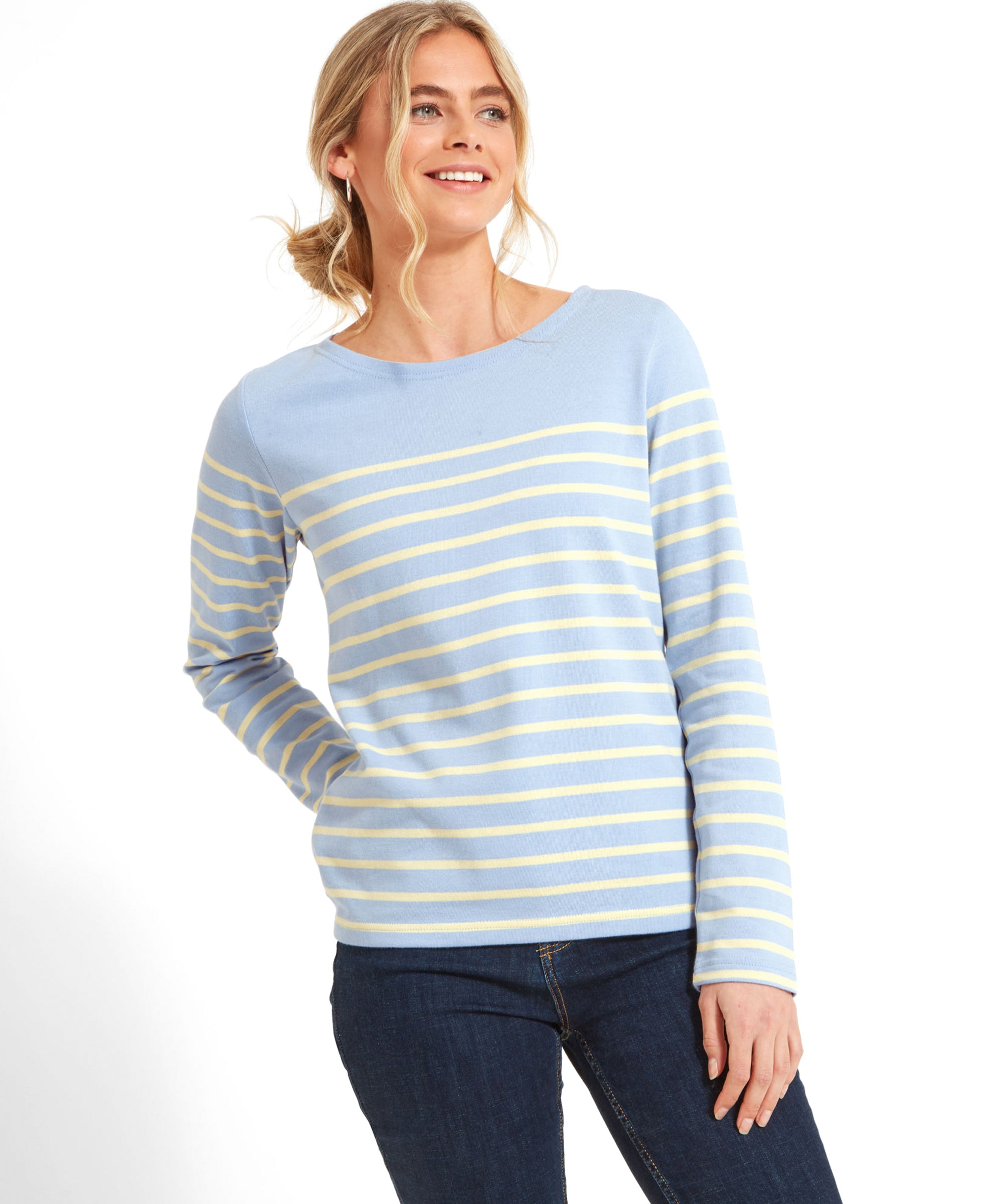 Woman wearing a Schöffel Beauport Top for Women in Yellow, paired with dark blue jeans.