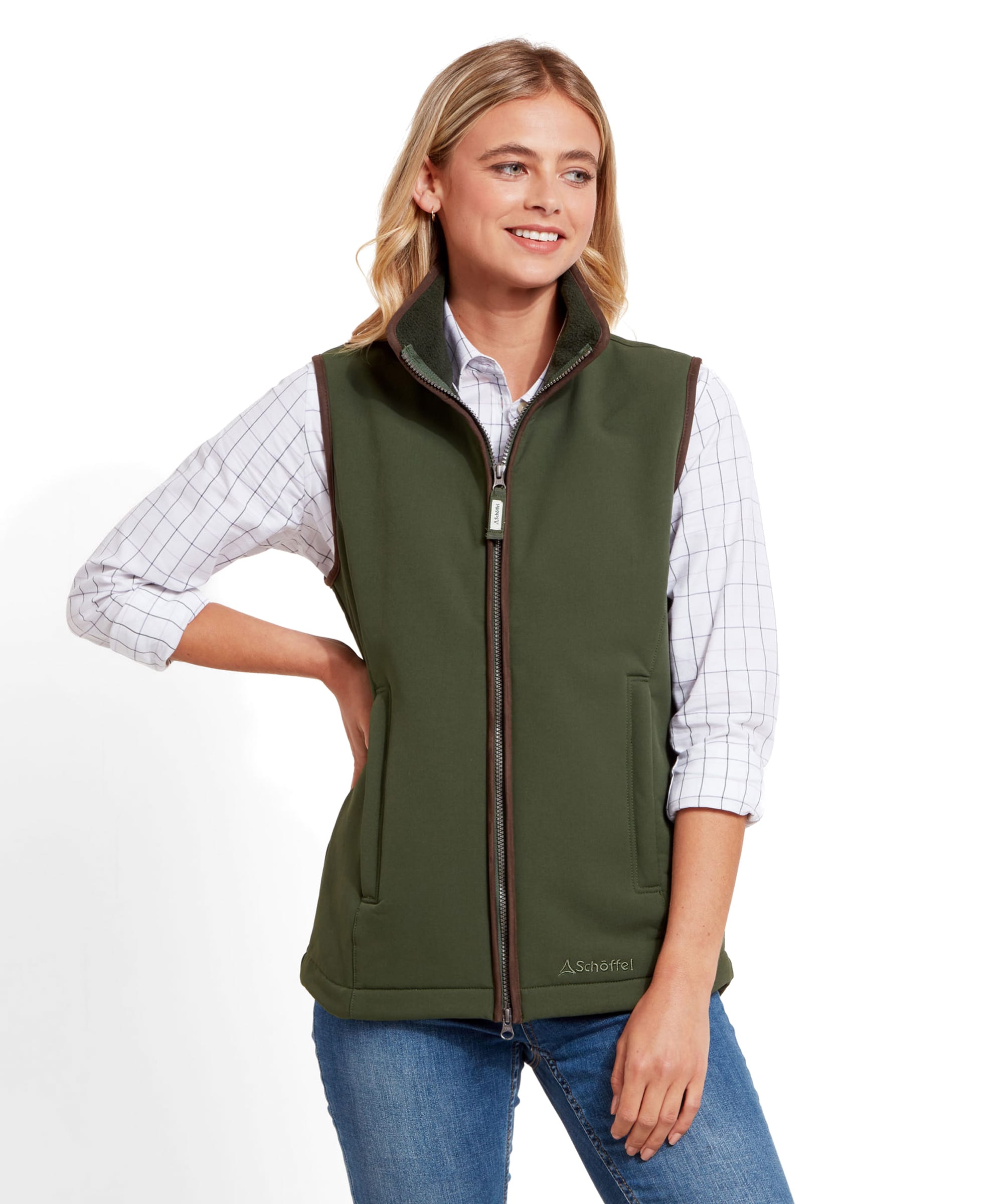 The same woman is seen from a slight angle, showing the back and side of the Schöffel Belton Gilet for Women in Green, which has a slightly tailored fit.