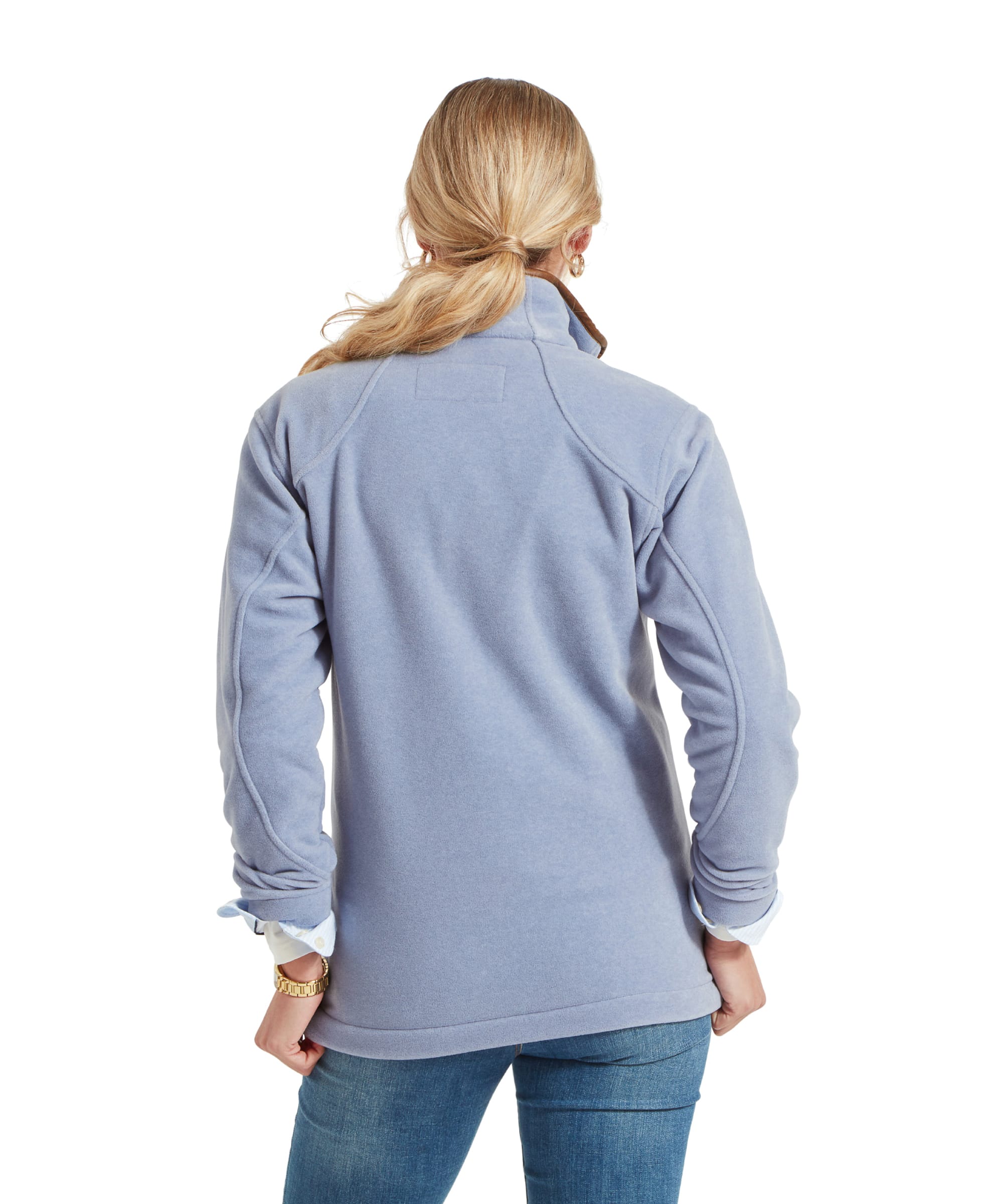 Back view of a woman wearing a Schöffel Burley Fleece Jacket for Women in Light Blue, showing the jacket’s length and fit. Her blonde hair is tied back, and she is wearing jeans.